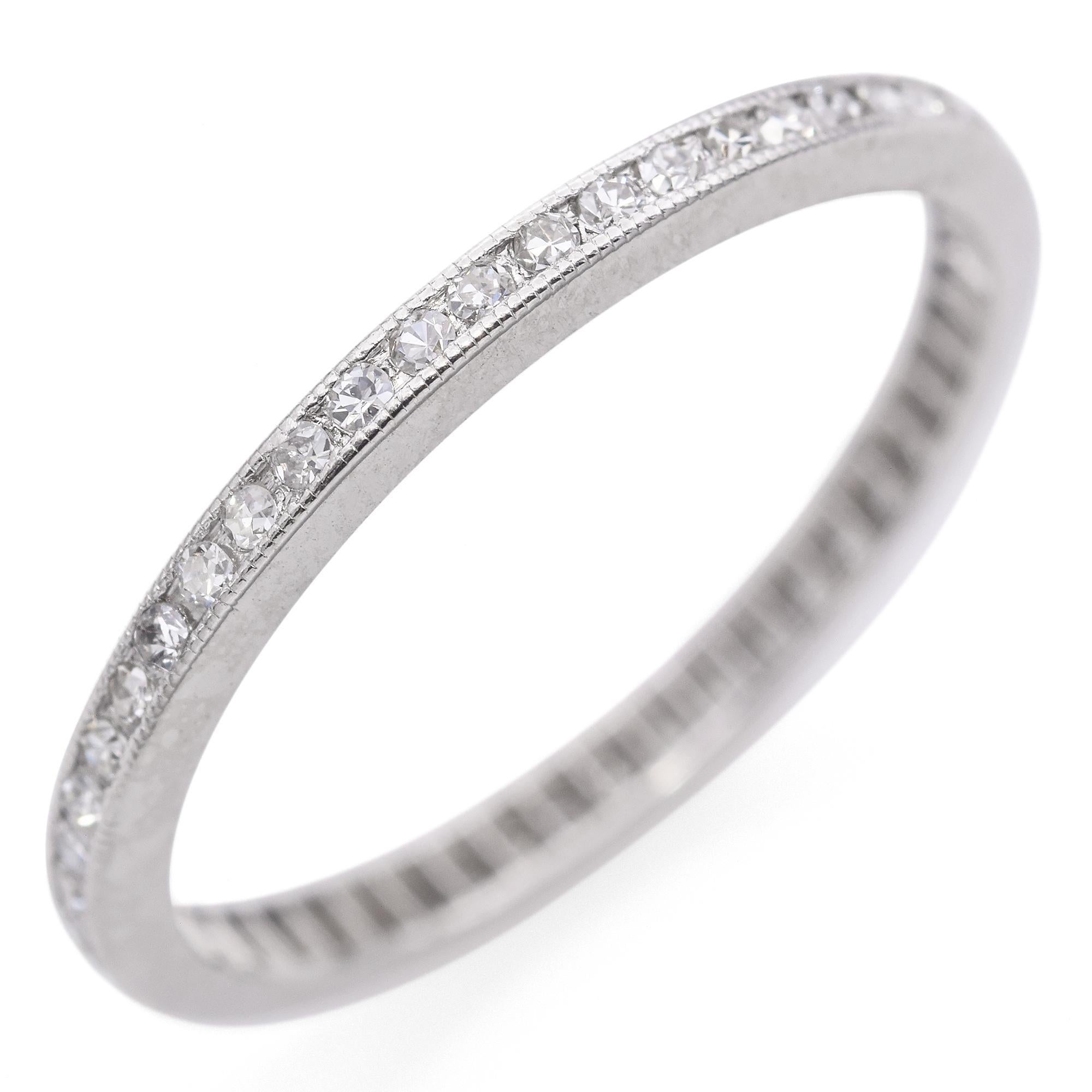 Experience the refined elegance of our Art Deco Diamond Band Ring. Expertly crafted from platinum, this exquisite piece features a delicate row of white diamonds, each meticulously set along a milgrain edge—a popular technique that peaked during the