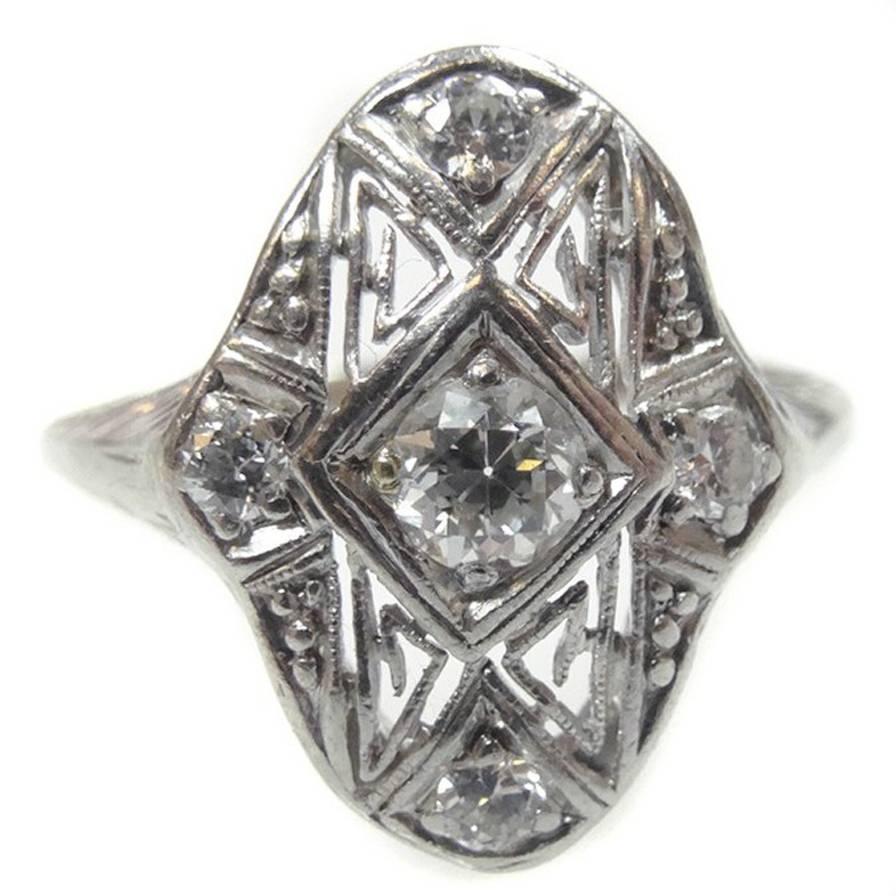 A delicate Art Deco ring made in fine platinum and prong-set with natural non-treated diamonds in the 12mm x 16mm crown - with an estimated 0.15 carats in the center stone and 0.12 carats in the 4 corner stones. Simply stunning. Measurements: 1/2