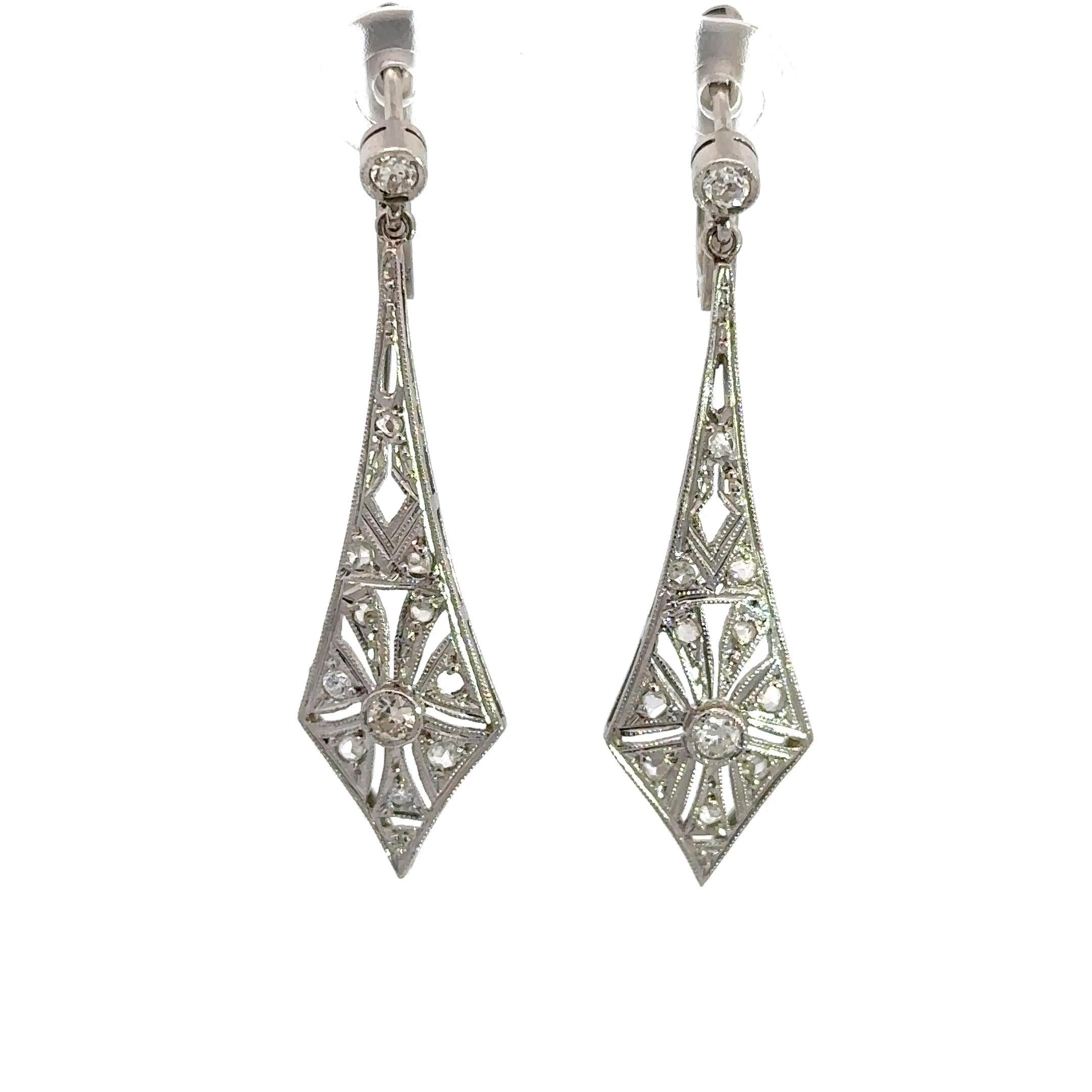 These vintage Art Deco pendulum earrings date from the 1920s. Crafted from platinum with a filigree design and approximately .75CT of rose-cut and old European cut diamonds.  The earrings measure 1.5 inches in length and weigh 5.7 grams. Why we love