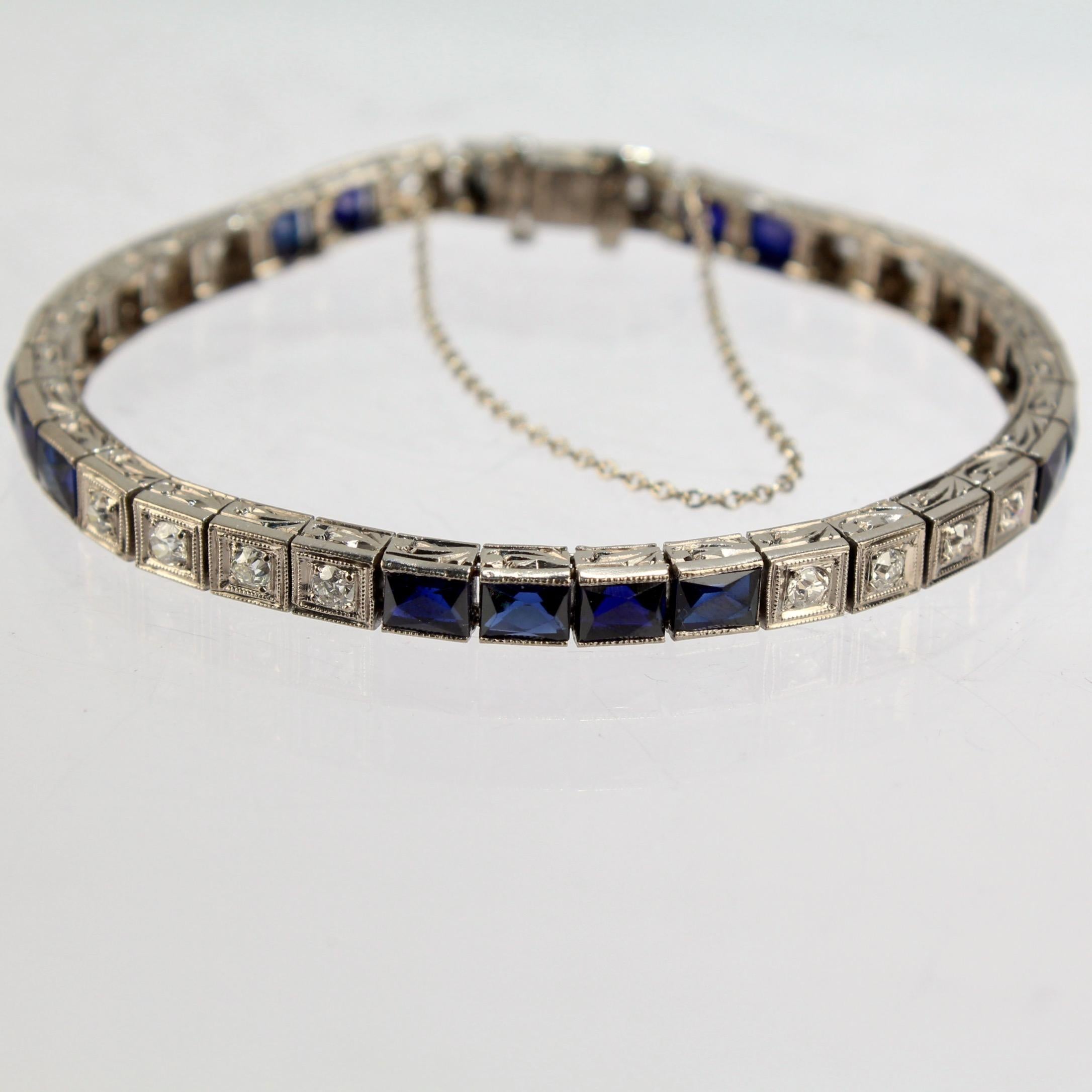 A very fine vintage Art Deco platinum, diamond, and sapphire tennis bracelet.

With alternating sets of four round-cut white diamonds and four French cut sapphires. 

Each stone is set in a separate link with engraved decoration to the sides.