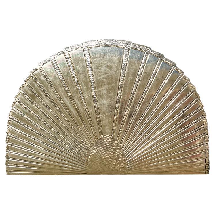 A set of four gold rubber placemats in the shape of a fan. This set will be great for a dinner party. Imagine them paired with bright bold plates and fun dinner napkins! Each piece is shaped to look like a fan but gives a very Art Deco vibe. The