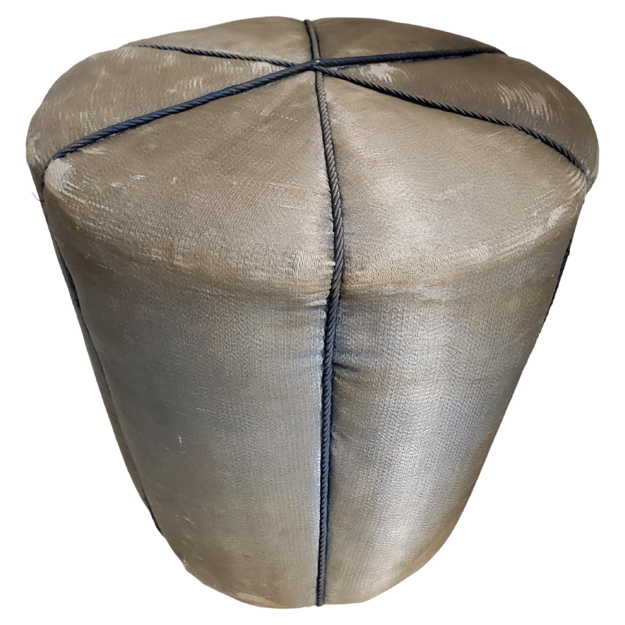 
An original and captivating Art Deco silk upholstered pouf, attributed to Jindrich Halabala for UP Závody. This stool exhibits a delightful conical shape cushion reminiscent of a harlequin's attire, divided into charming sections. 
Its full round