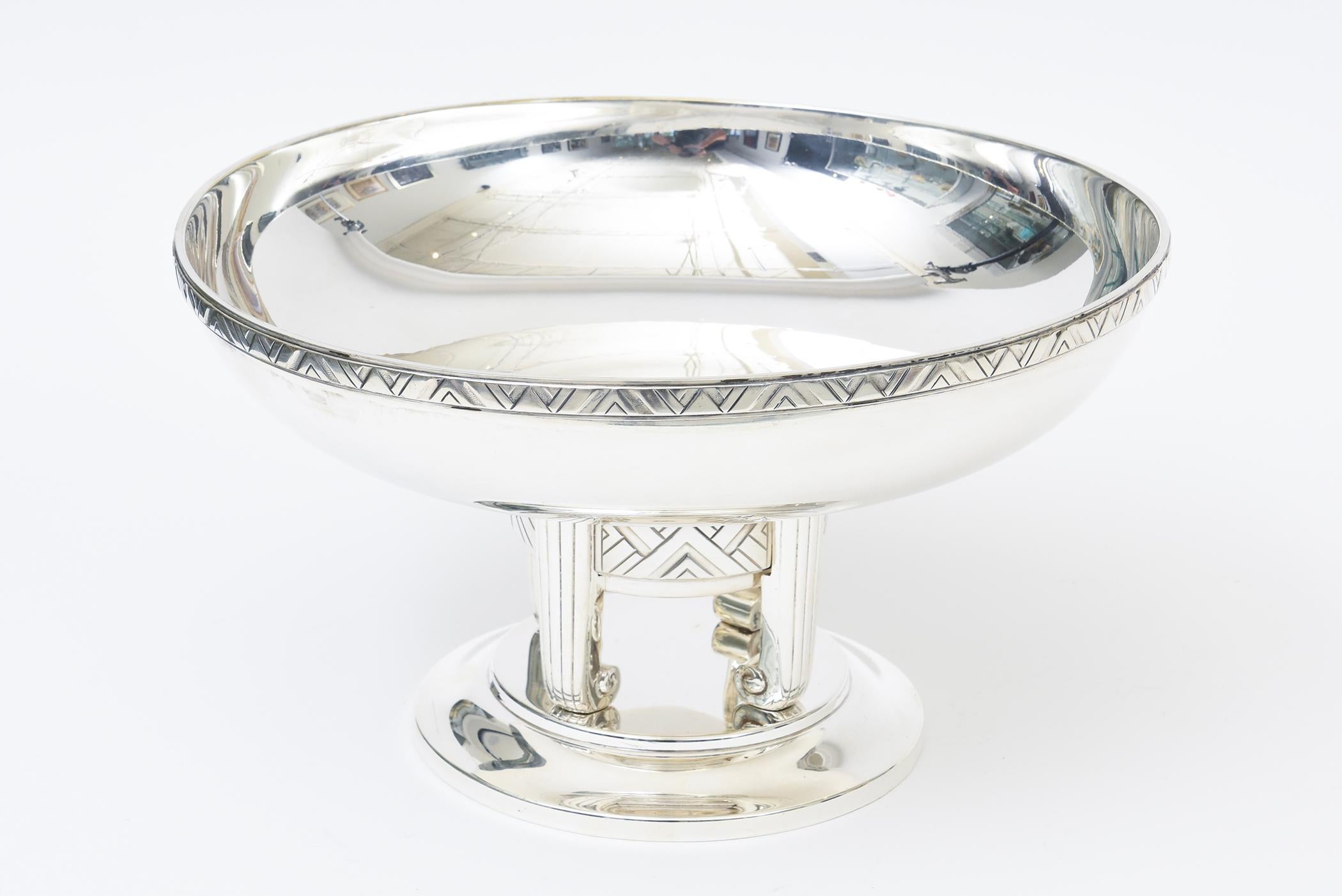 This very special and very rare fully restored Silver plated Art Deco large pedestal bowl and or centerpiece bowl was done in the 1930's by Apollo Metalsmith Company from NY.  It is hallmarked on the bottom Apollo 25 with another hallmark of a VH