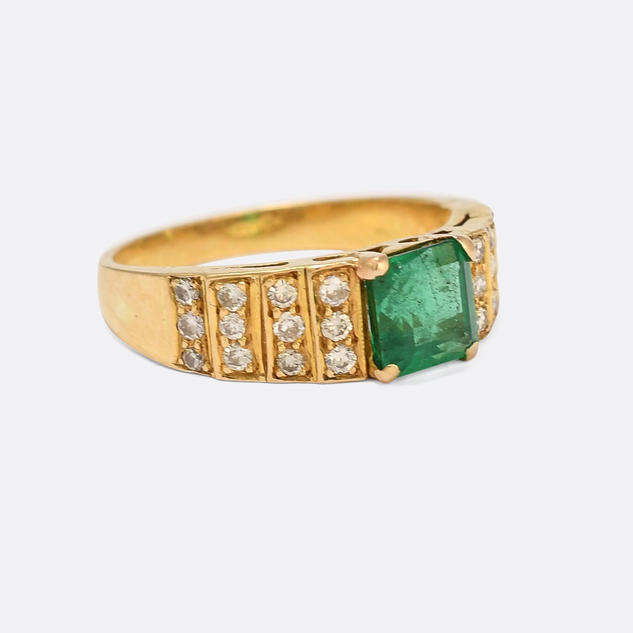 A stunning 1970s Art Deco Revival solitaire ring set with a central 1.28ct emerald flanked by diamond-set stepped shoulders. The principal stone is certified Zambian, and displays excellent colour and clariry - a subtle hint of blue adding depth to