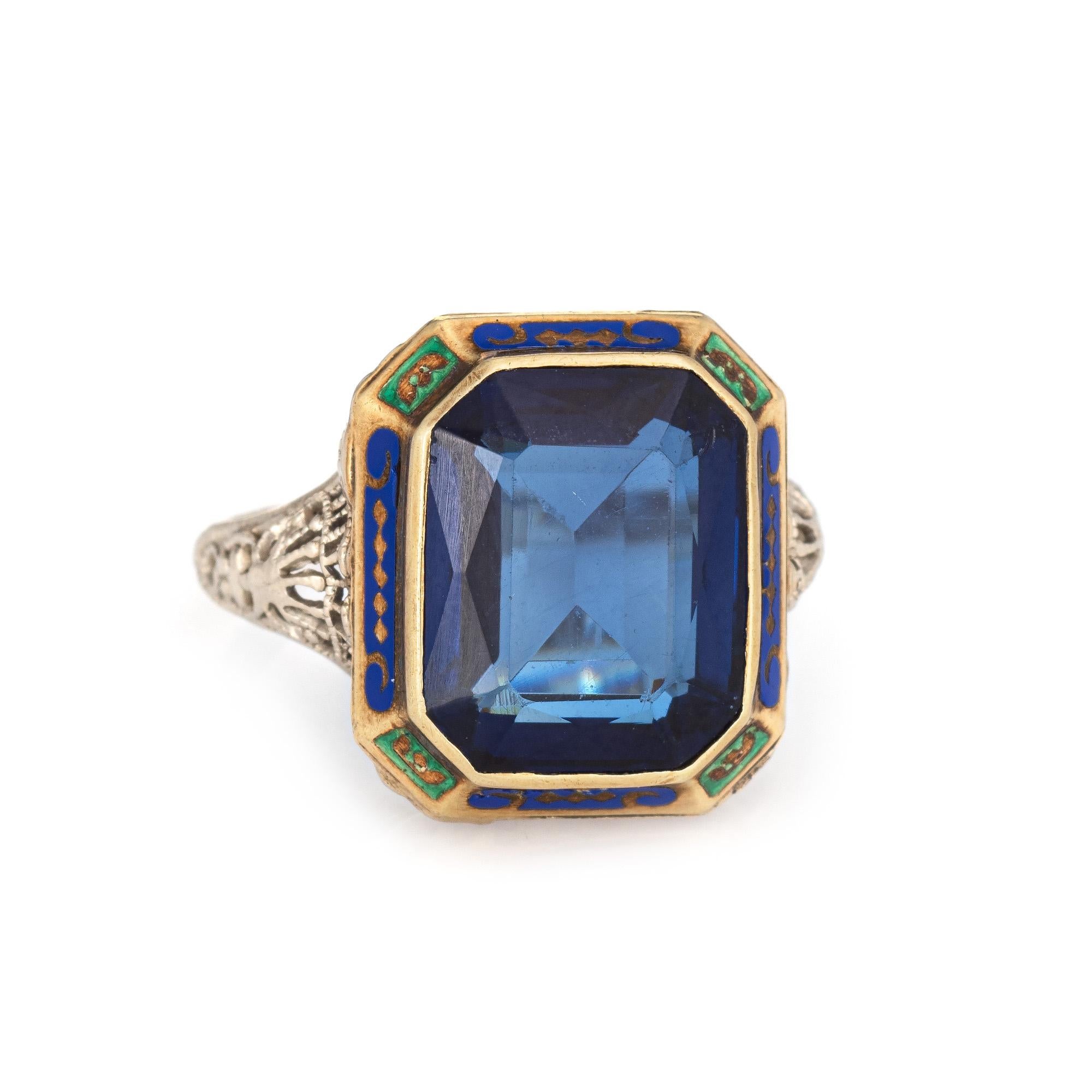 Finely detailed vintage Art Deco era blue stone enamel ring (circa 1920s to 1930s) crafted in 14k white gold. 

Faceted square cut lab created blue stone measures 12mm x 9mm. The stone shows some light abrasions visible under a 10x loupe. 

The