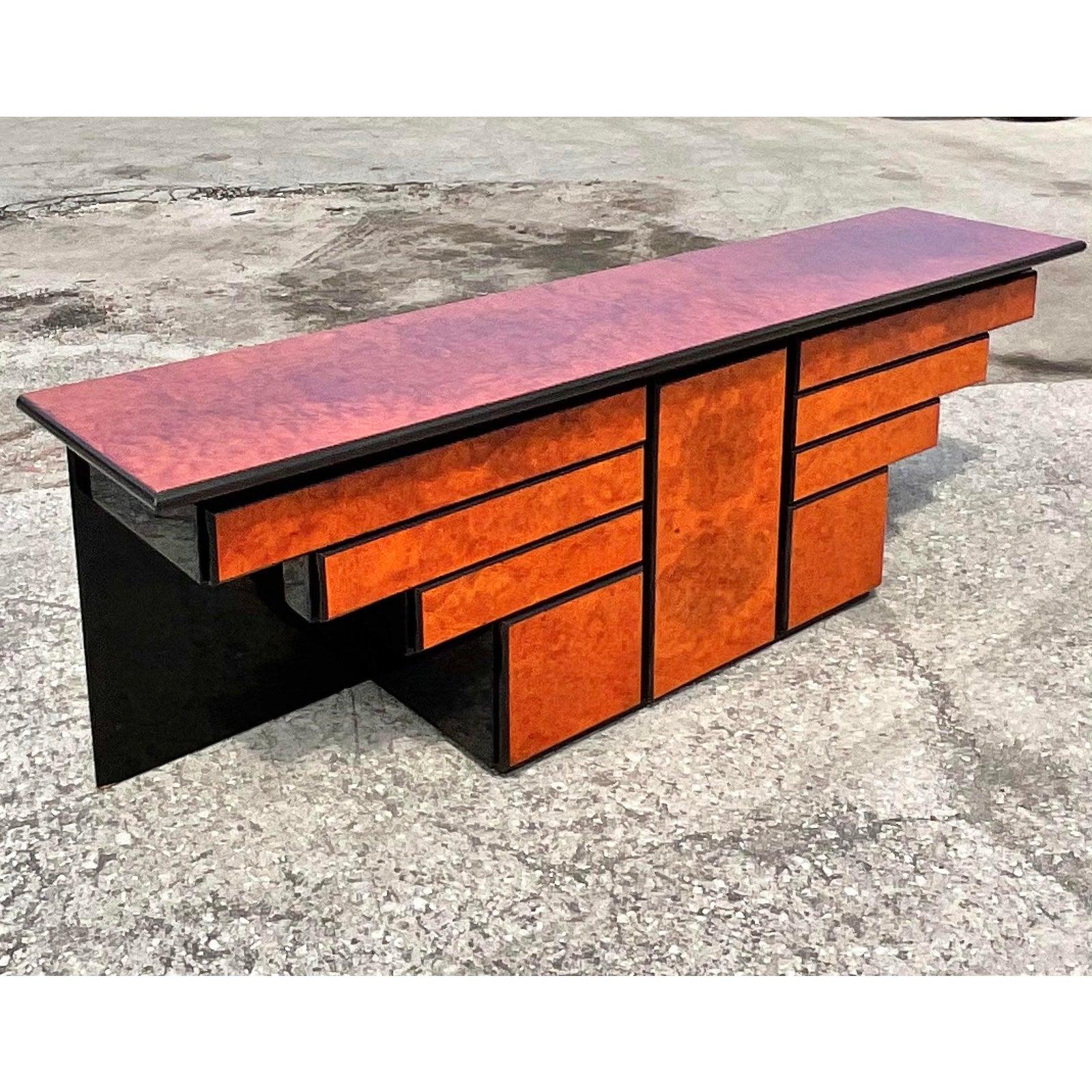 Fantastic vintage Roche Bobois credenza. Chic stacked design with a high gloss lacquered finish. Beautiful wood grain detail. Made in Spain. Matching dining table available. Acquired from a Palm Beach estate.