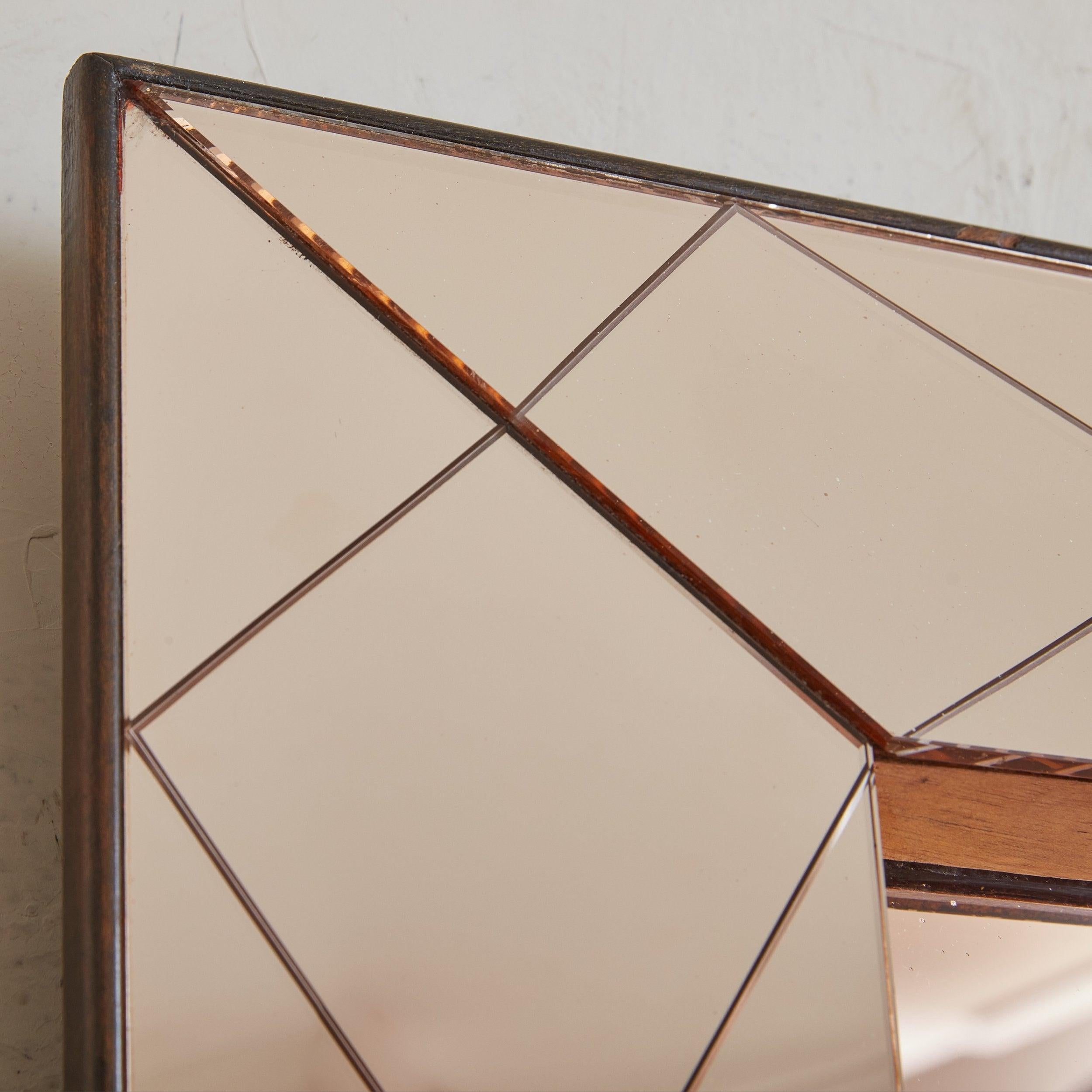 A vintage Art Deco rectangular wall mirror featuring stunning rose gold hued mirror glass and a coordinating etched diamond design. The frame is constructed of wood and inset with traditional mirrored glass. The frame is not flush with the mirror