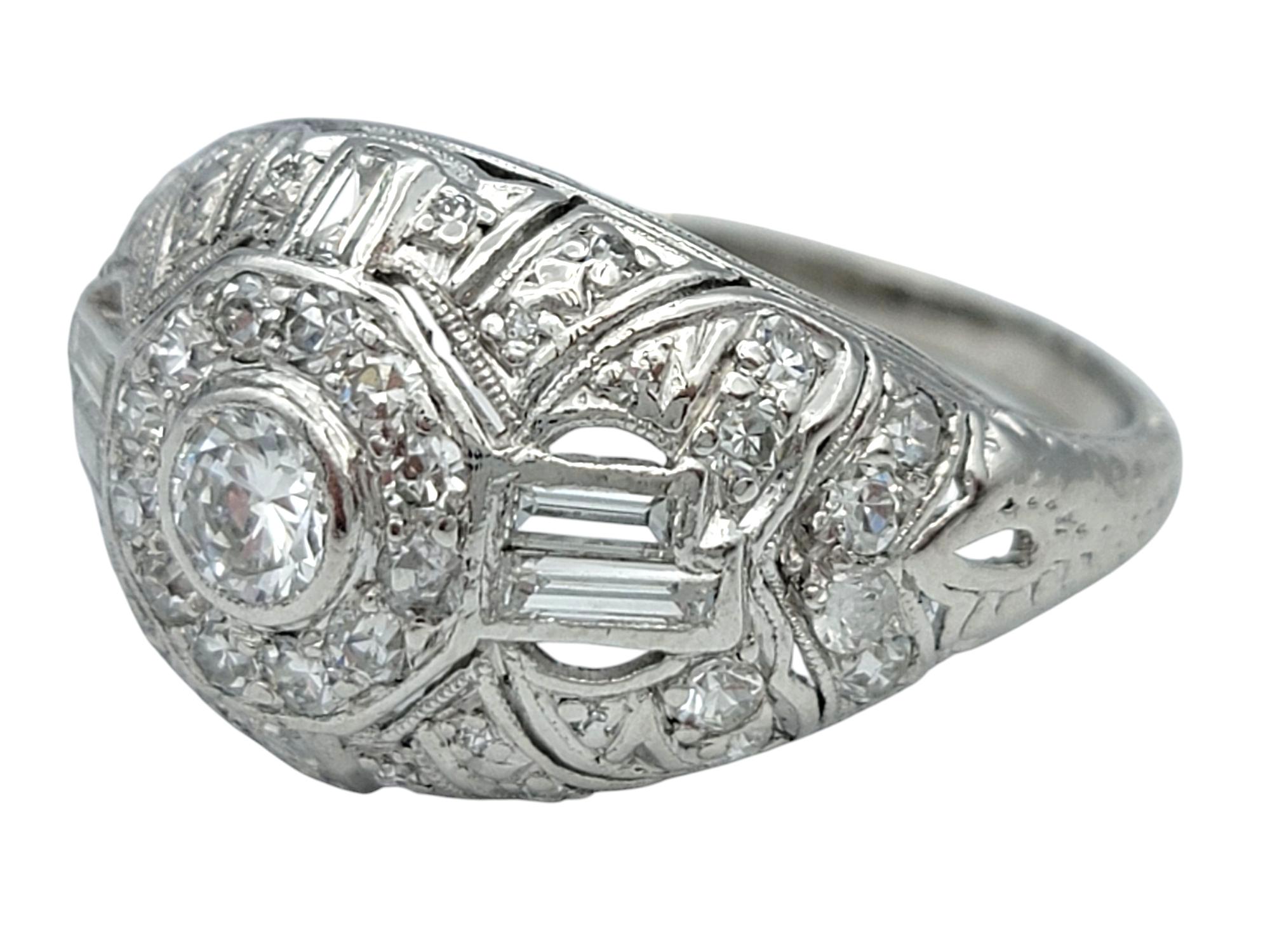Ring Size: 7.75

Striking and sculptural, this diamond ring dazzles with architectural elegance and platinum strength. Featuring a harmonious blend of round and baguette cut diamonds, the ring offers a captivating play of brilliance and geometry.