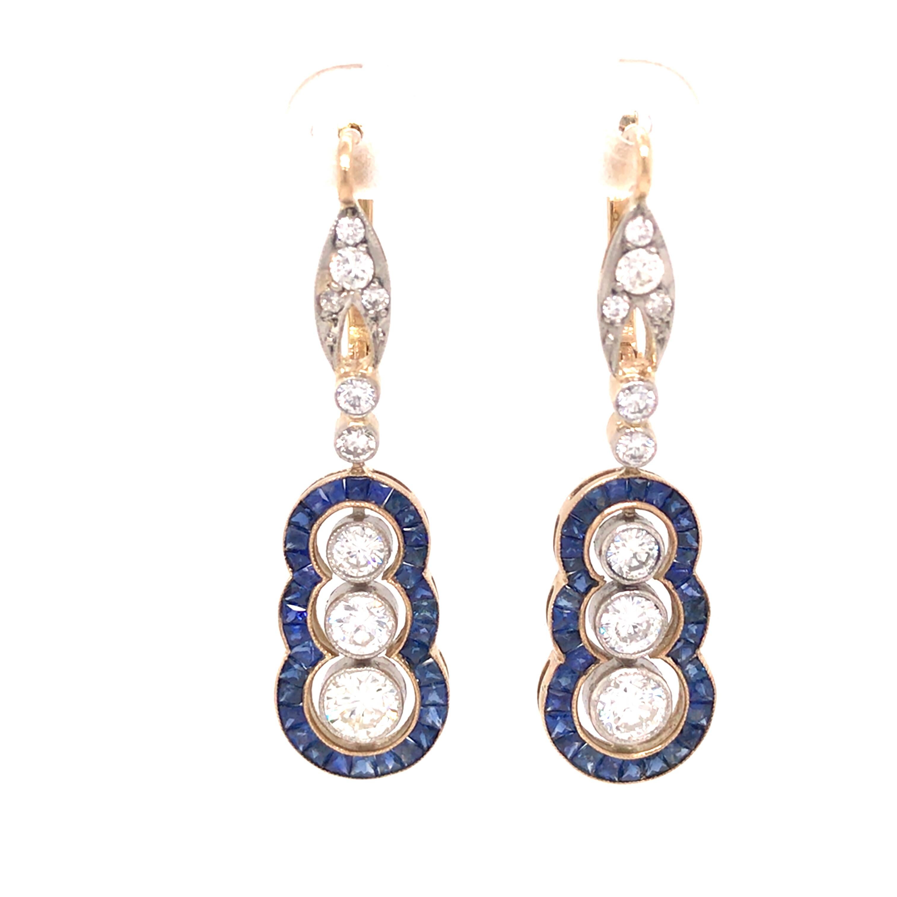 Vintage Art Deco Sapphire Diamond Hanging Earring in 18K Yellow Gold and Platinum.  Round Brilliant Cut Diamonds weighing 3.0 carat total weight, G-I in color and VS-SI in clarity are expertly set with Sapphires weighing 2.0 carat total weight.  The