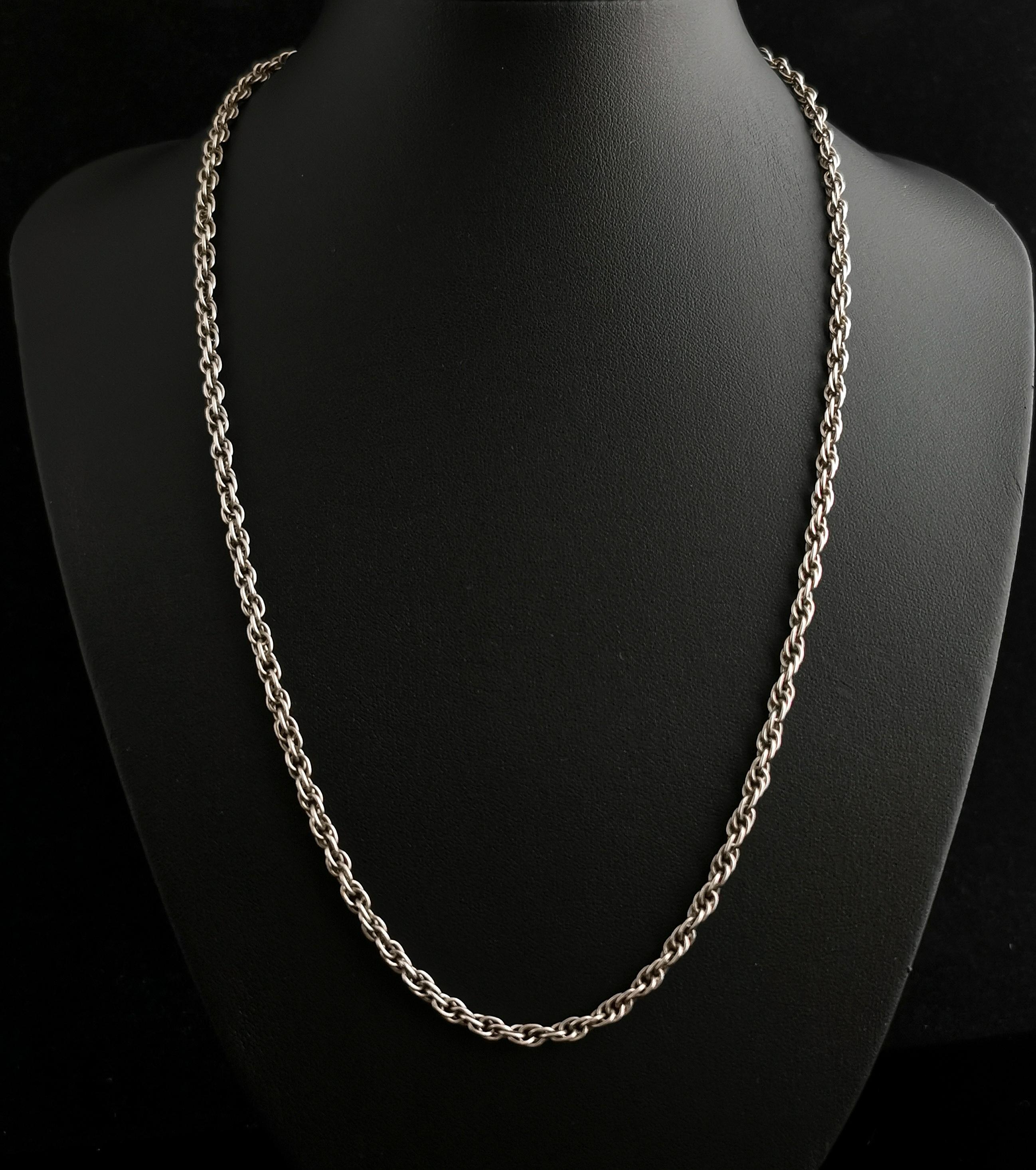 An attractive vintage c1930s sterling silver fancy rope link chain necklace.

It has a fancy elongated rope type link with a spring ring fastener marked silver.

It is a nice wearable link, perfect for adding your favourite vintage lockets or