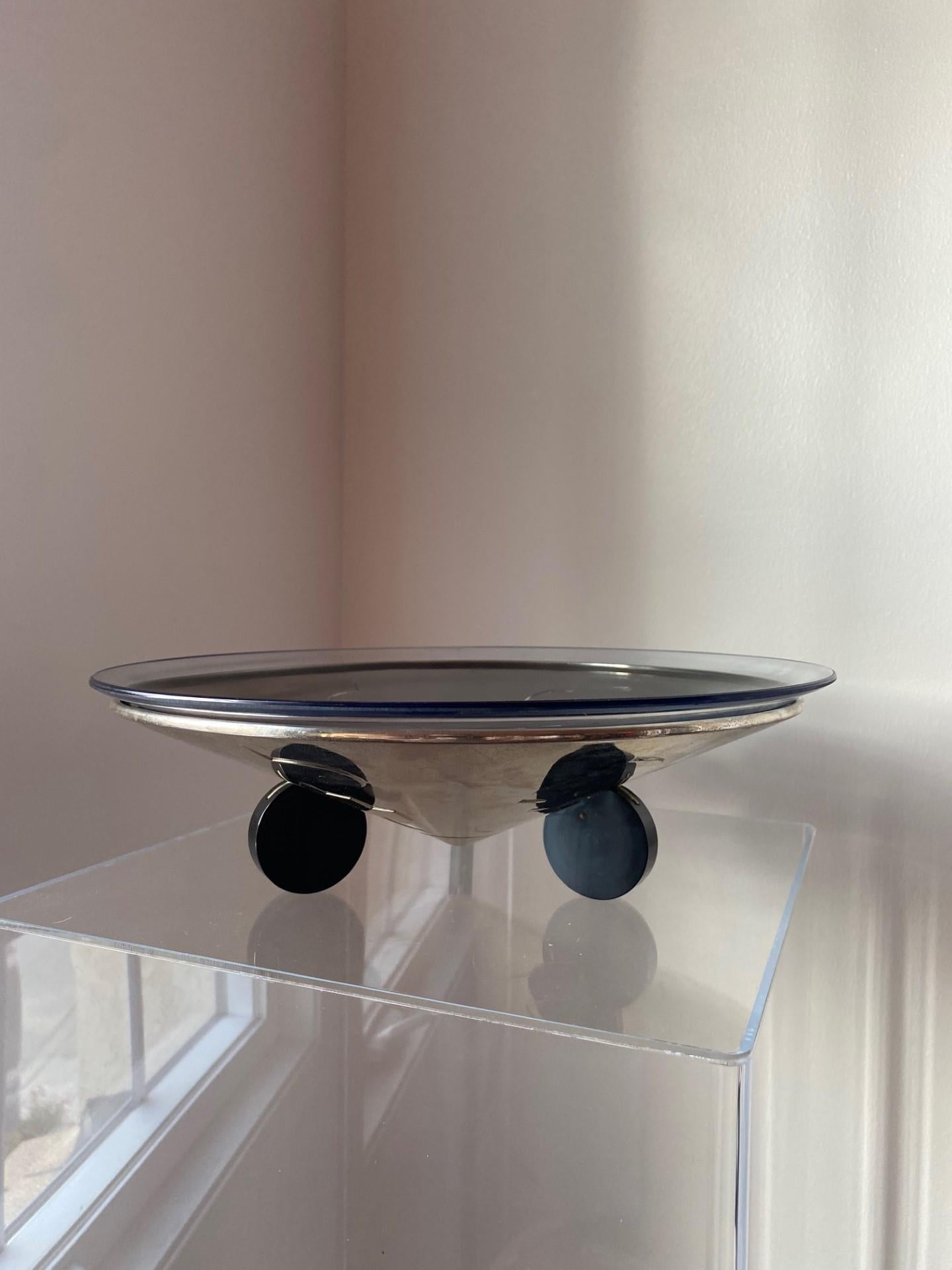 This beautiful art deco decorative bowl is sublime and unique.  This piece originates from the 1930’s and came from an estate of an avid art deco collector. The silver plated bowl in chrome finish has a puzzle like design. The bowl is suspended over