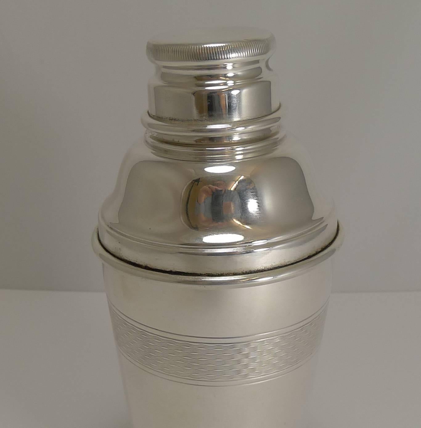 A handsome vintage silver plated cocktail shaker with engine-turned decoration.

The underside is marked EPNS for Electro-Plated Nickel Silver.

Art Deco in era and dating to circa 1930 and English in origin. Excellent condition; measure: 8