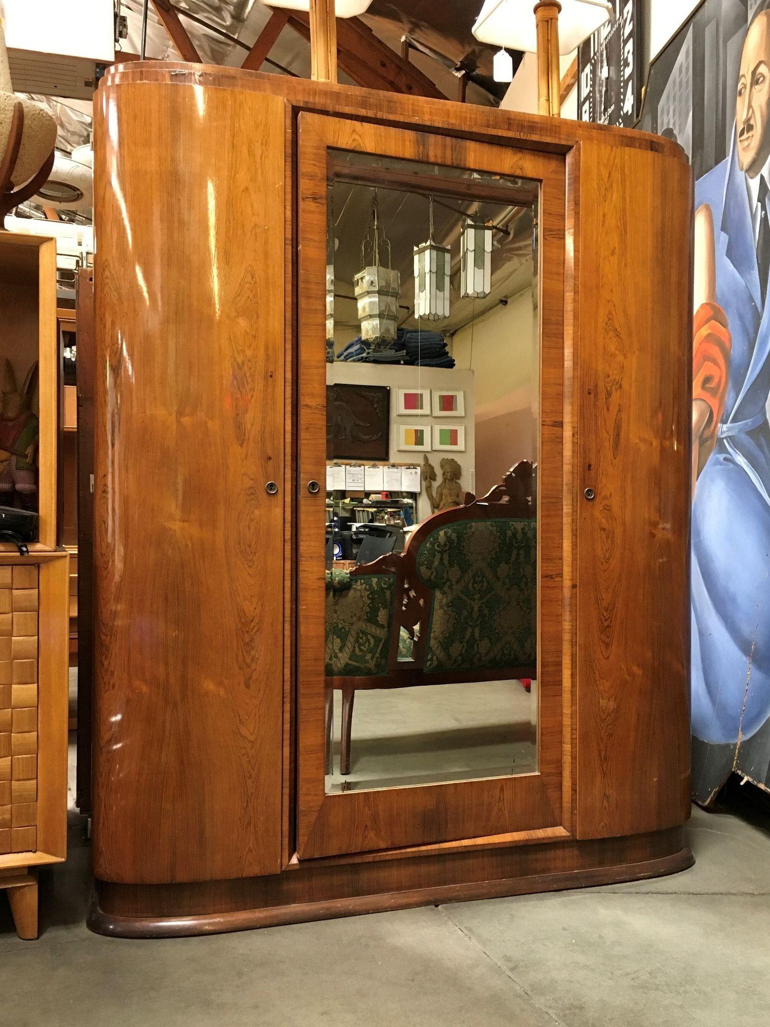Vintage Art Deco Solid Walnut Wood Armoire / Wardrobe.$1,475
 
This solid walnut wood armoire has been made to last. Originally made in France, it features a total 3 front doors. Middle one has a mirror insert with beautiful beveled edges. 2 side