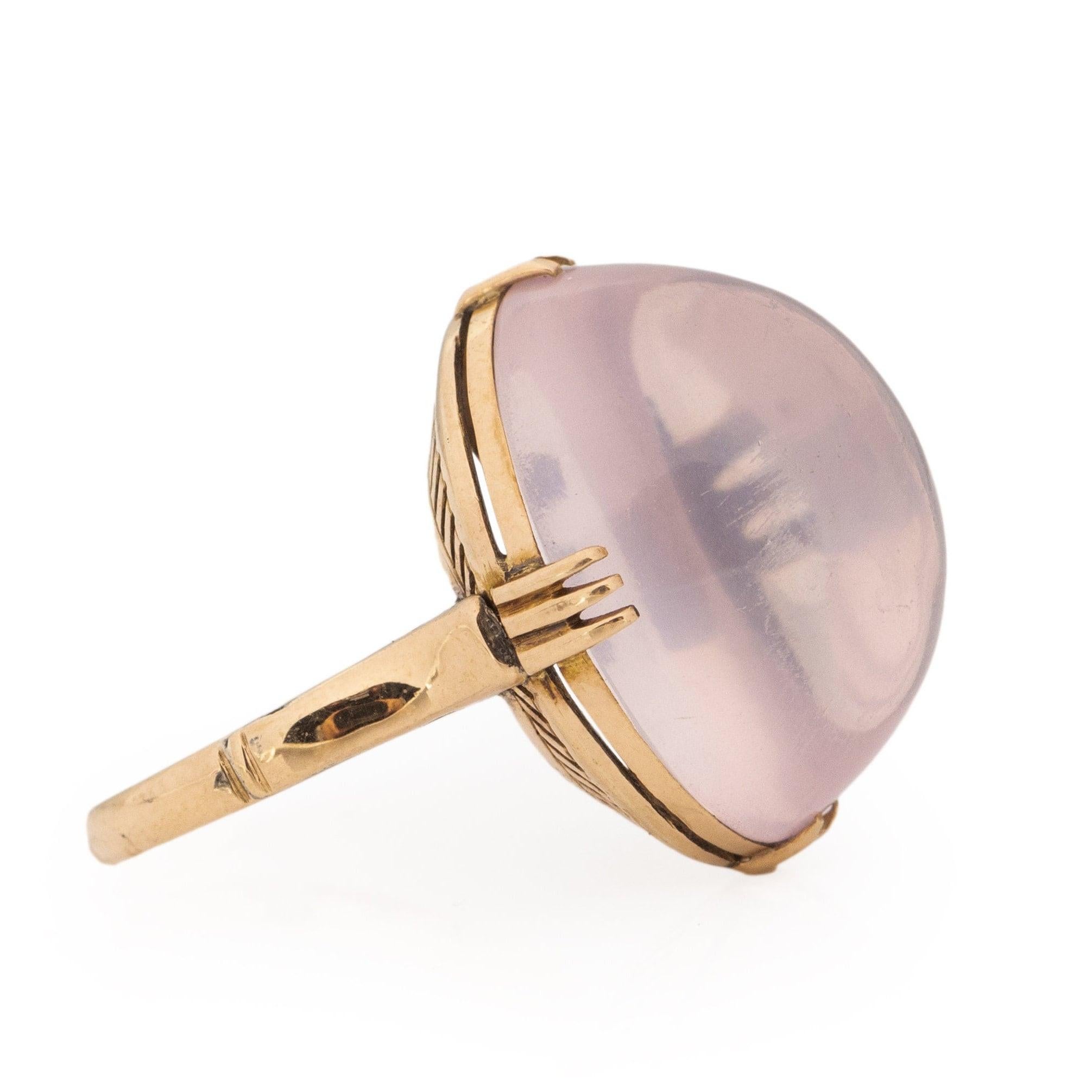 Behold this truly distinctive beauty! The central moonstone, an approximately 18.3Ct oval cabochon, showcases a stunning lavender hue that adds an extraordinary touch. Nestled in an 18K yellow gold prong setting, the gumdrop-shaped moonstone finds