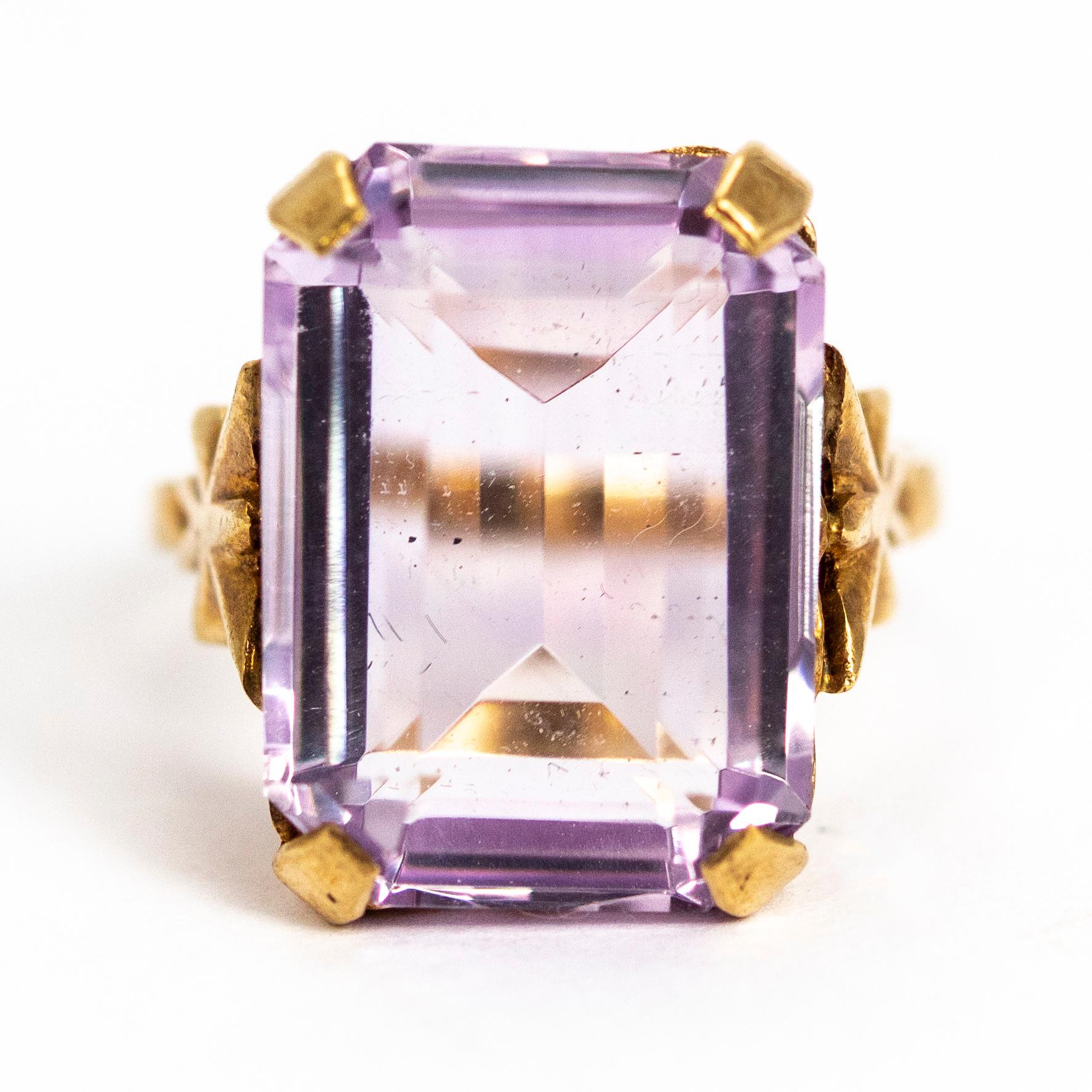 A superb vintage Art Deco style cocktail ring set with a wonderful pale purple tall emerald cut amethyst. The stone sits in a beautiful gallery with exquisite butterfly motif shoulders. Modelled in 9 carat yellow gold. Fully hallmarked 1972