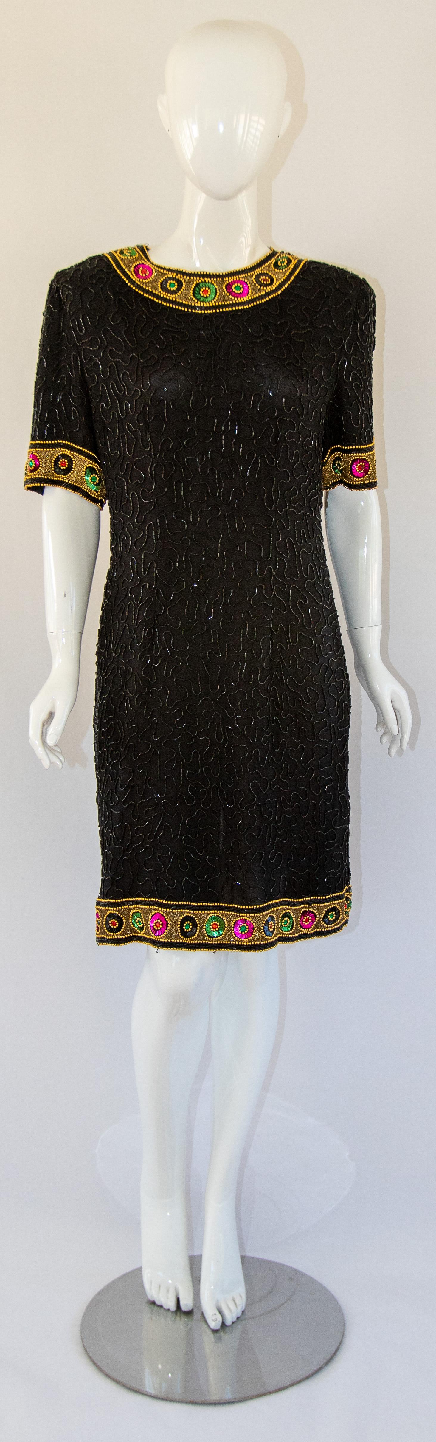 Art Deco Style Beaded Mini Dress Black and Gold by Laurence Kazar New York.
1980s black 100 % pure silk sequin cocktail dress beaded short dress.
Vintage black mini dress heavily beaded with black & gold beads.
Completely covered in beads, with a