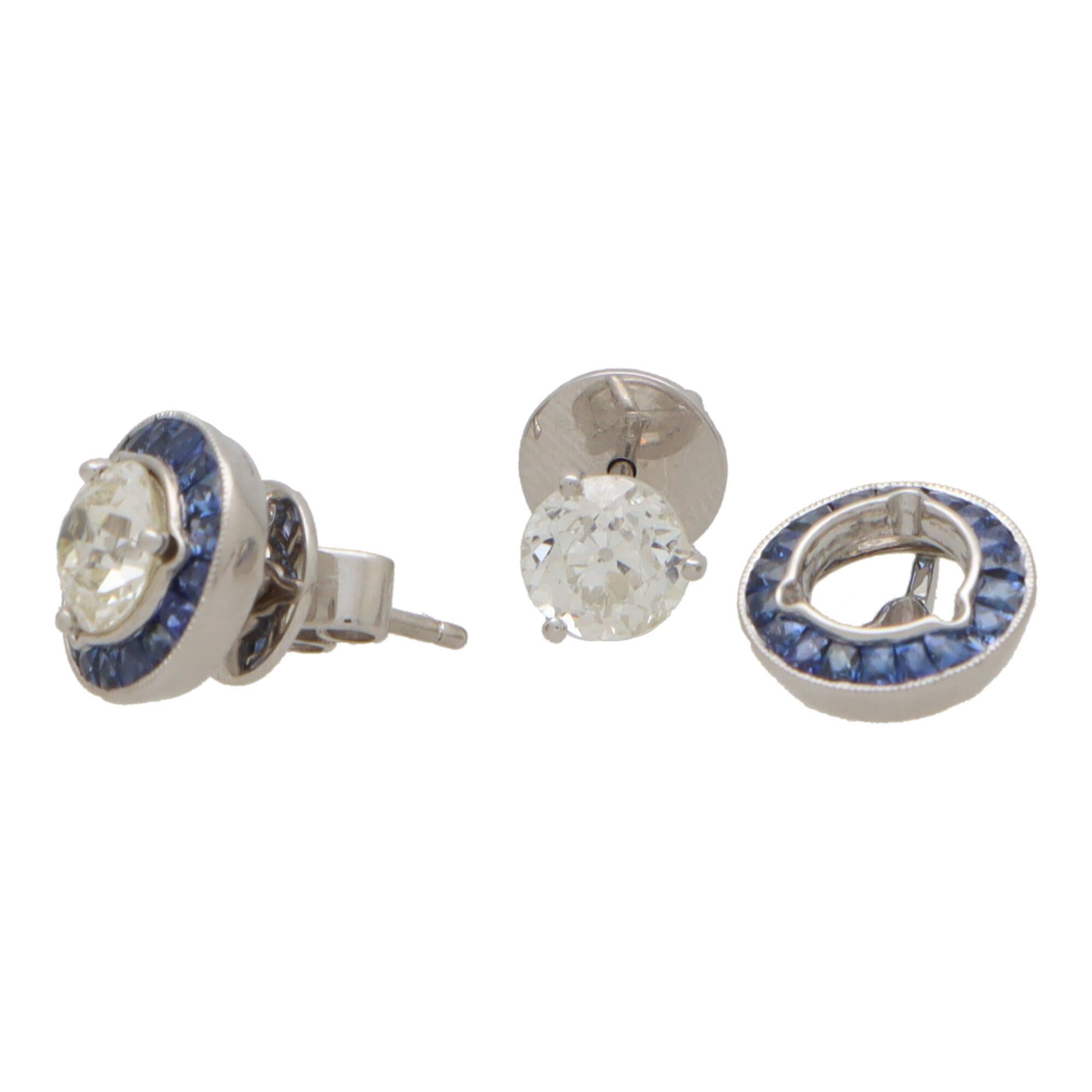 A beautiful pair of Art Deco style convertible diamond and sapphire target earrings set in platinum.

Each earring is predominantly set with a sparkly 1.04 carat old European cut diamond which is three claw set to centre. Each diamond is then