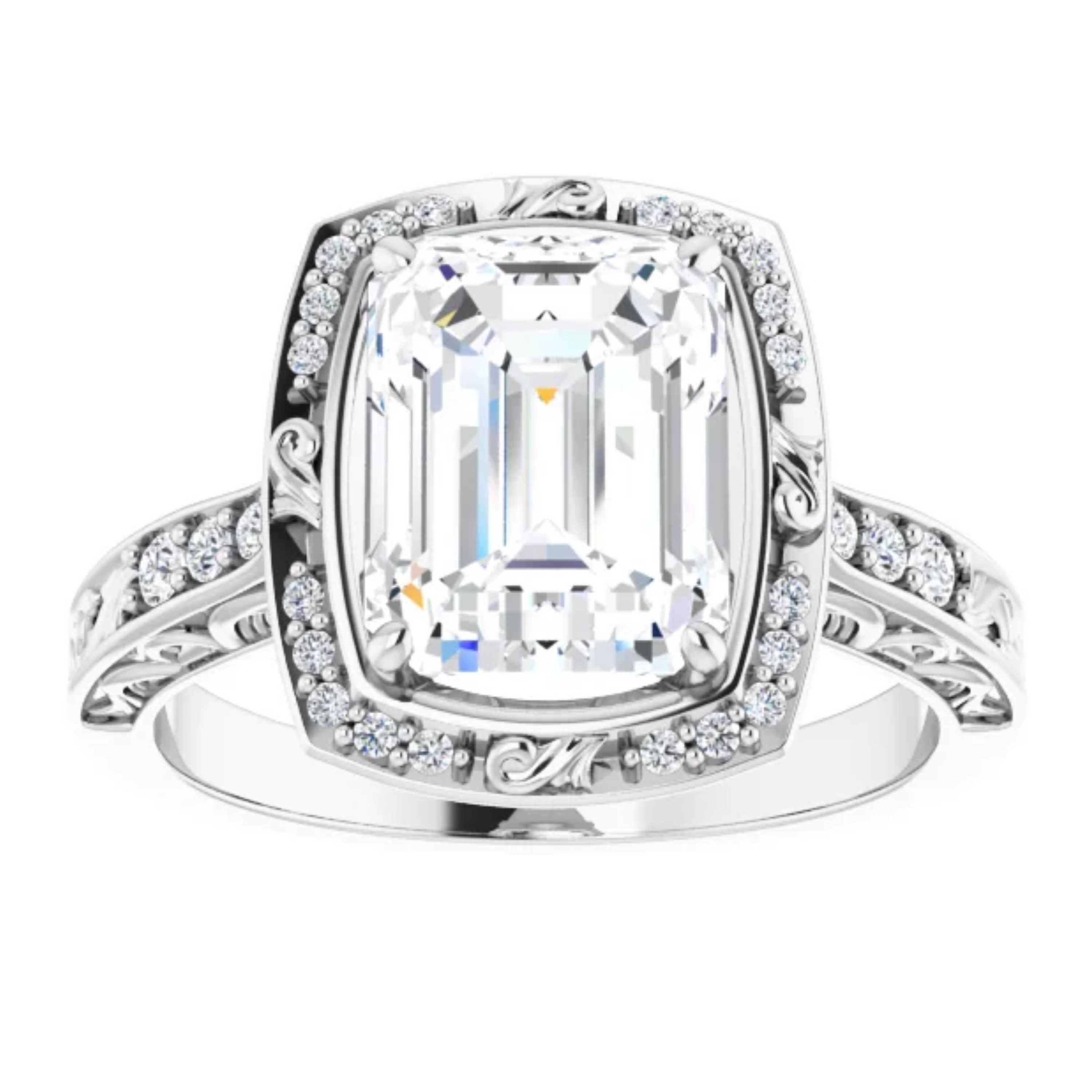 The GIA certified emerald cut center diamond on this beautiful engagement ring is ornamented with adorable filigrees and a halo of shimmering white diamonds. Additional diamonds and intricate filigrees float along the shank. Handcrafted in 14k white