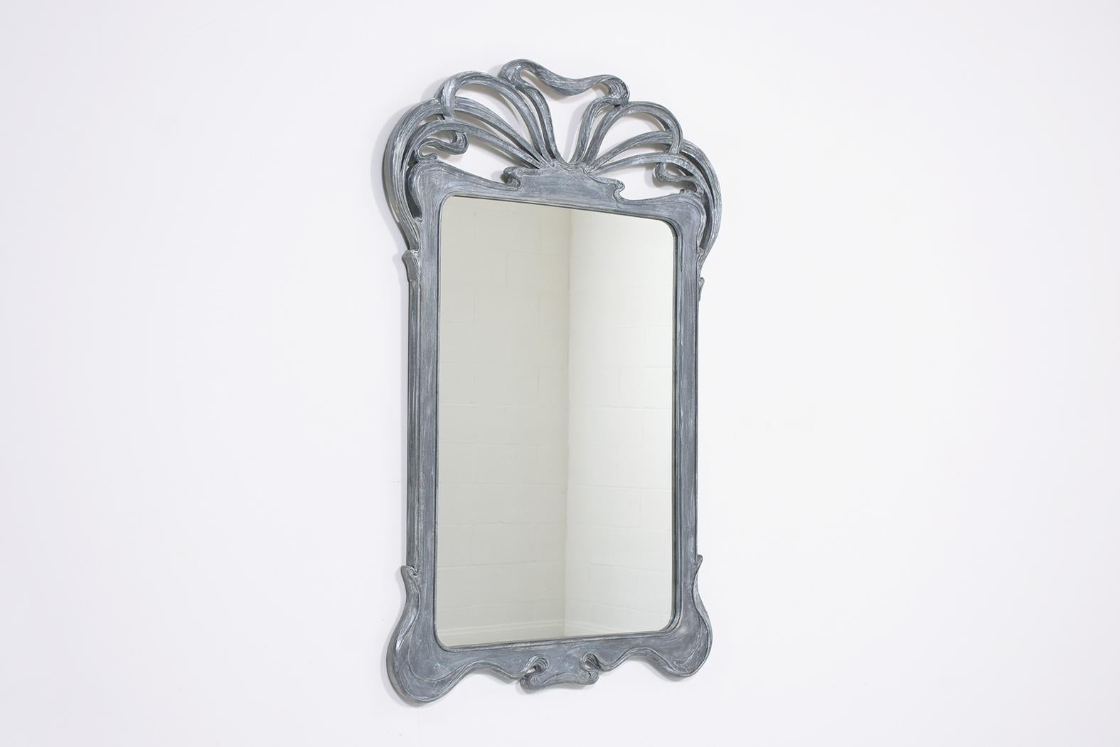 This extraordinary vintage art deco-style wall mirror is in excellent condition crafted out of mahogany wood and has been fully restored by our team of expert craftsmen. This fabulous mirror is the perfect addition to the displayed or compliments a