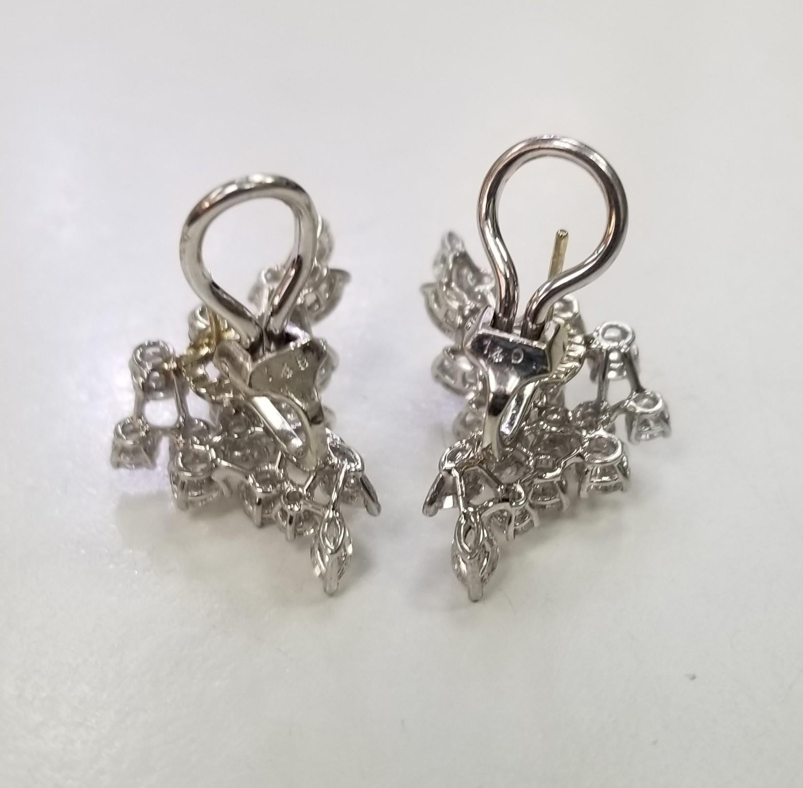 This is a Platinum vintage art deco style pair of diamond Earrings.  There are approximately 4.02 carat total weight of white brilliant diamonds in the flower design. The diamonds, made up of round and marquise cuts are appraised as F-G color and