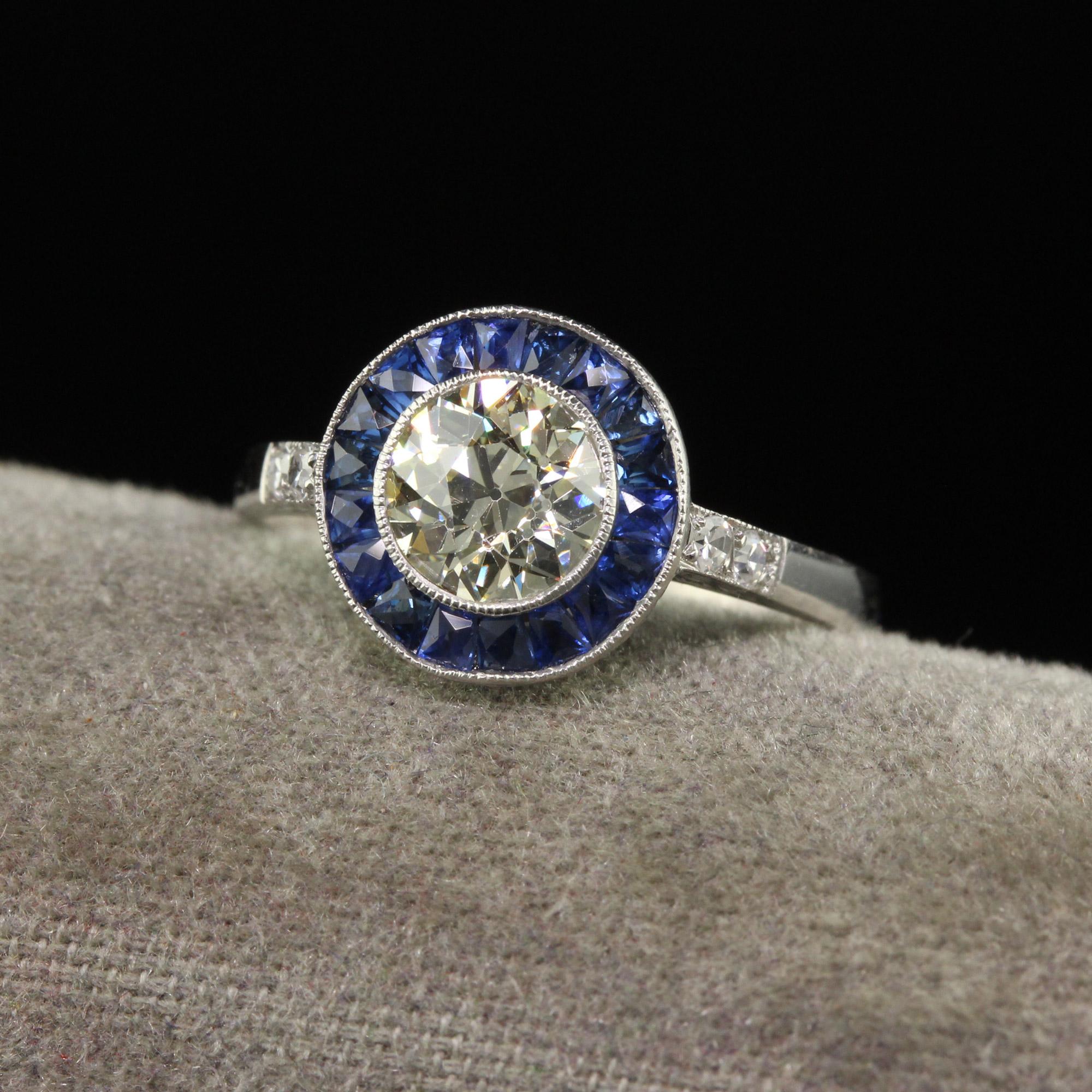 Beautiful Vintage Art Deco Style Platinum Old European Diamond and Sapphire Halo Engagement Ring - GIA. This gorgeous engagement ring is crafted in platinum. The center is set with an old European cut diamond that has a GIA report and is surrounded