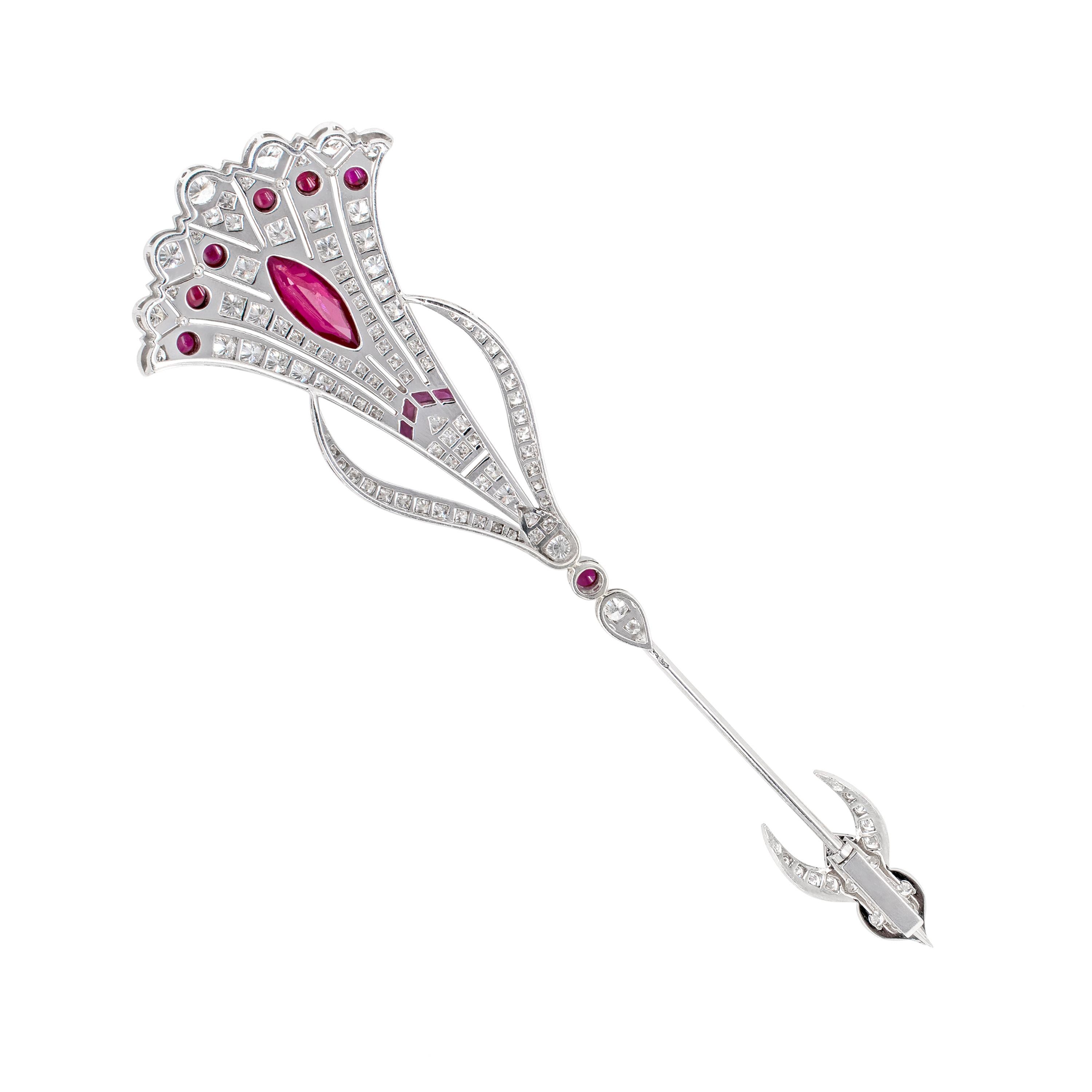 Fan jabot pin set with a vibrant marquise shaped ruby with an approximate weight of 1.40 carats, rub-over set in the center of a beautifully intricate diamond grain set design. There are approximately 3.00 carats of fine quality round diamonds in