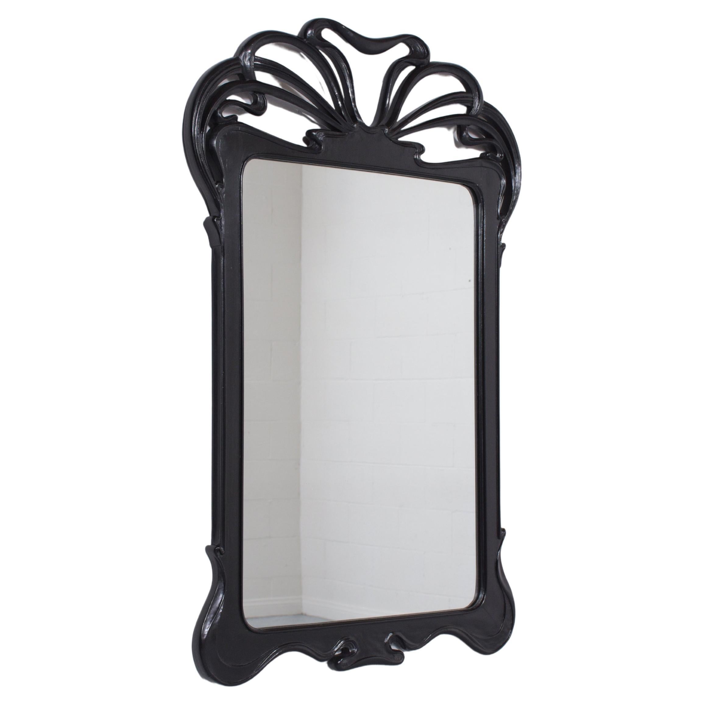 This extraordinary vintage Art Deco-style wall mirror is in excellent condition crafted out of mahogany wood and has been fully restored by our team of expert craftsmen. This mantel mirror features a new painted black color with satin-lacquer