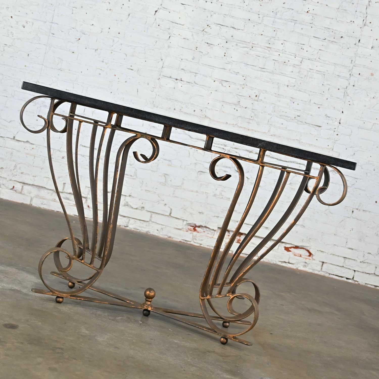 Gorgeous vintage Art Deco style wrought iron console table with painted faux gold leaf finished base and a solid granite top. Beautiful condition, keeping in mind that this is vintage and not new so will have signs of use and wear. There are no