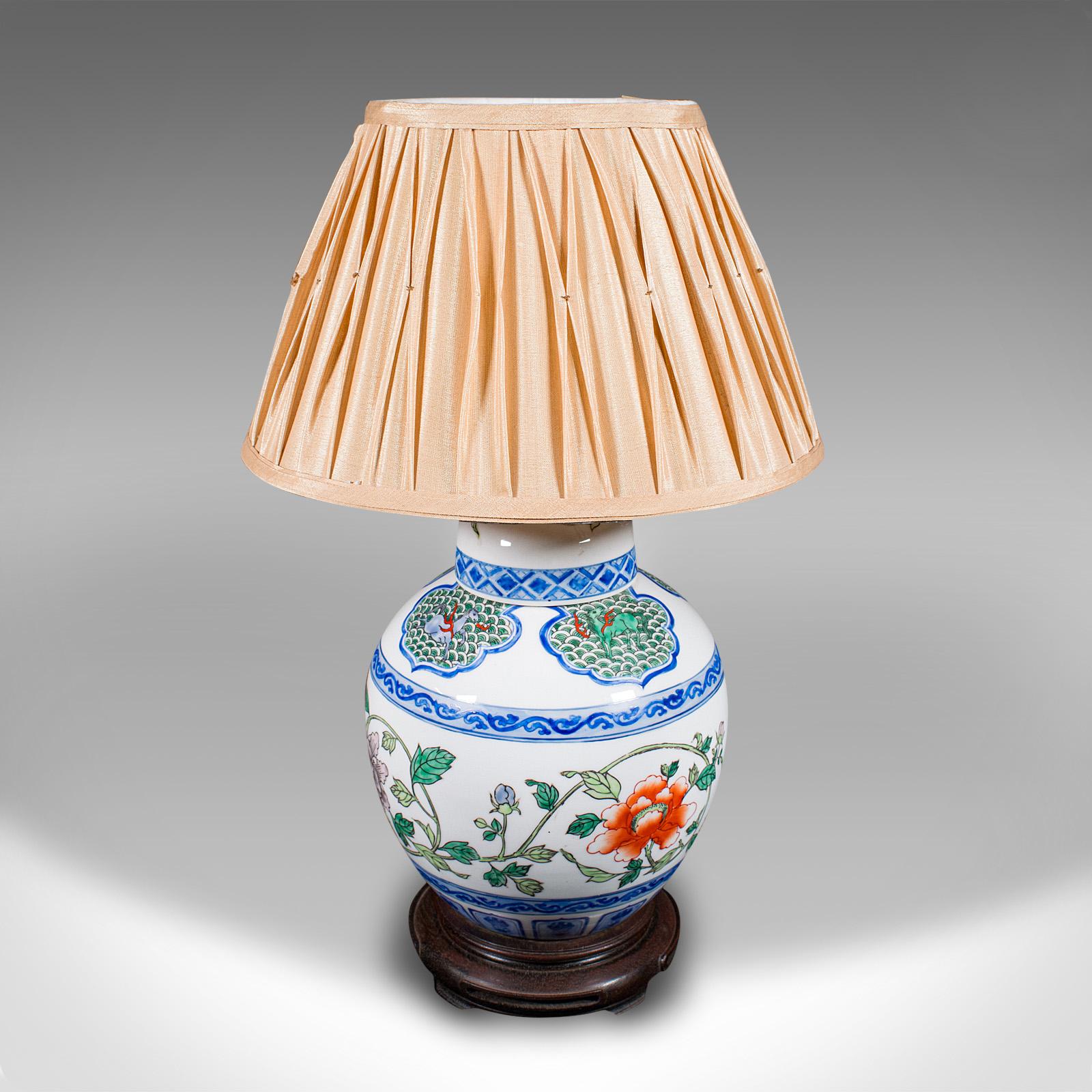 This is a vintage Art Deco table lamp. A Chinese, ceramic accent light, dating to the mid 20th century, circa 1950.

Cheerful Oriental Art Deco taste with a colourful finish
Displaying a desirable aged patina and in good order
Quality white ceramic