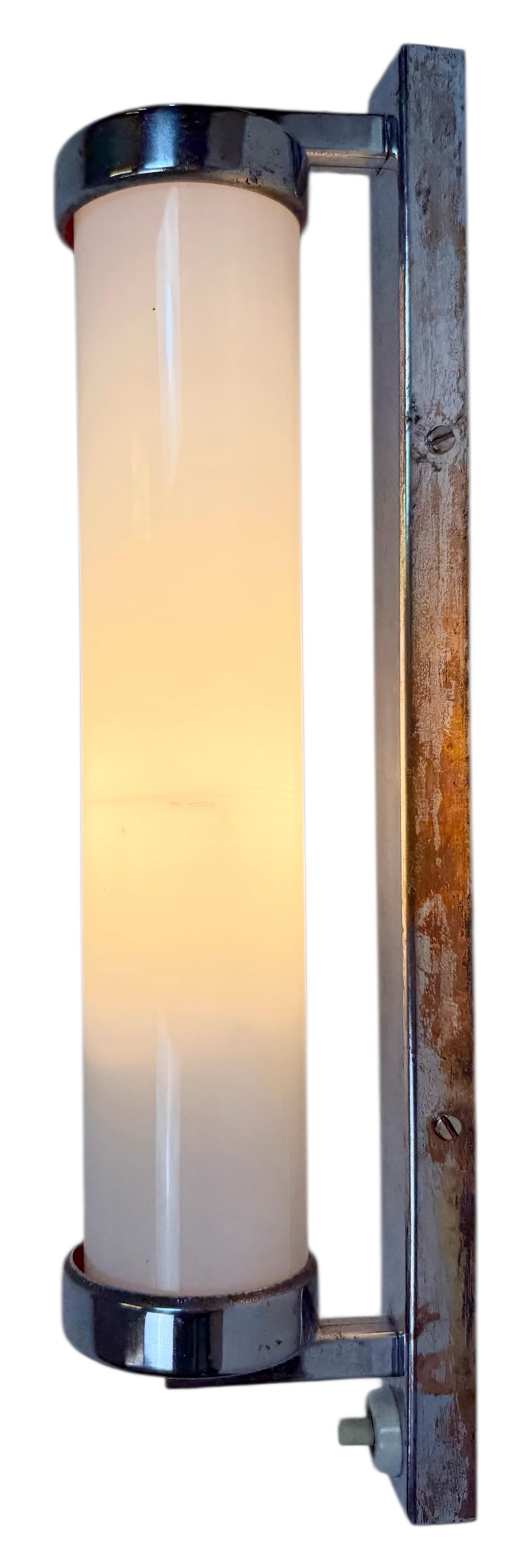 Vintage art deco light made in former Czechoslovakia during  the 1930s. It features a rusty metal chrome plated wall mounting with swich and an opaline glass. The socket requires standard E14 ligh bulbs. New wire. The weight of the lamp is 0,6 kg.