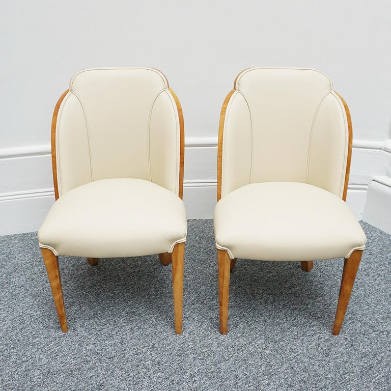 A Pair of Art Deco Cloud chairs by Harry & Lou Epstein. Burr walnut veneered with figured walnut banding. Re-upholstered in cream leather. 

Dimensions: H 87cm W 50cm D 45cm

Origin: English

Date: Circa 1935

Item Number: 0907222

All of