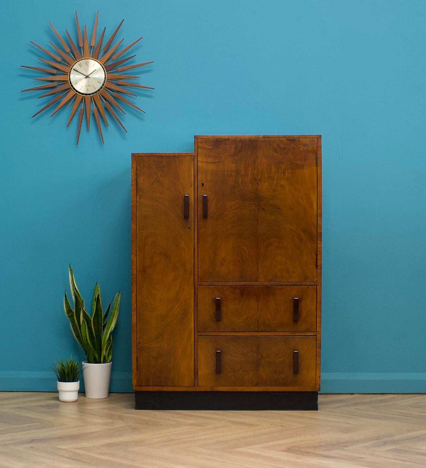 An impressive quality 1930s Art Deco two tier burr walnut linen cabinet with an ebonised plinth
Featuring two cupboards with shelves and two external drawers
Very similar in style and quality to Heals
The handles are made from bakelite