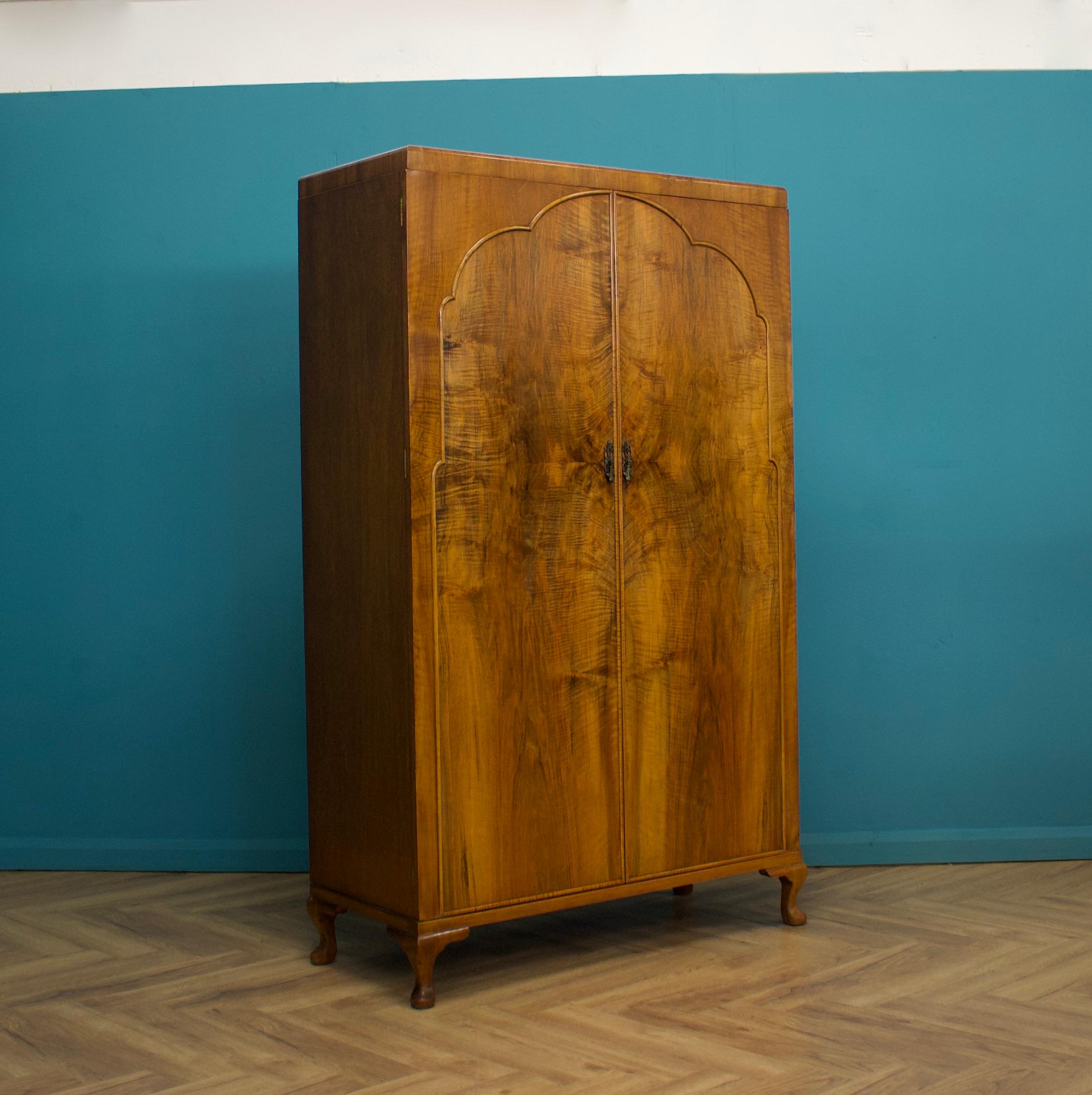 An impressive quality Art Deco burr walnut wardrobe


Made by Waring and Gillow, circa 1930s


Standing on Queen Anne style feet


Featuring two clothes rails and a shelf




The walnut veneers are in beautiful original


The original key is not