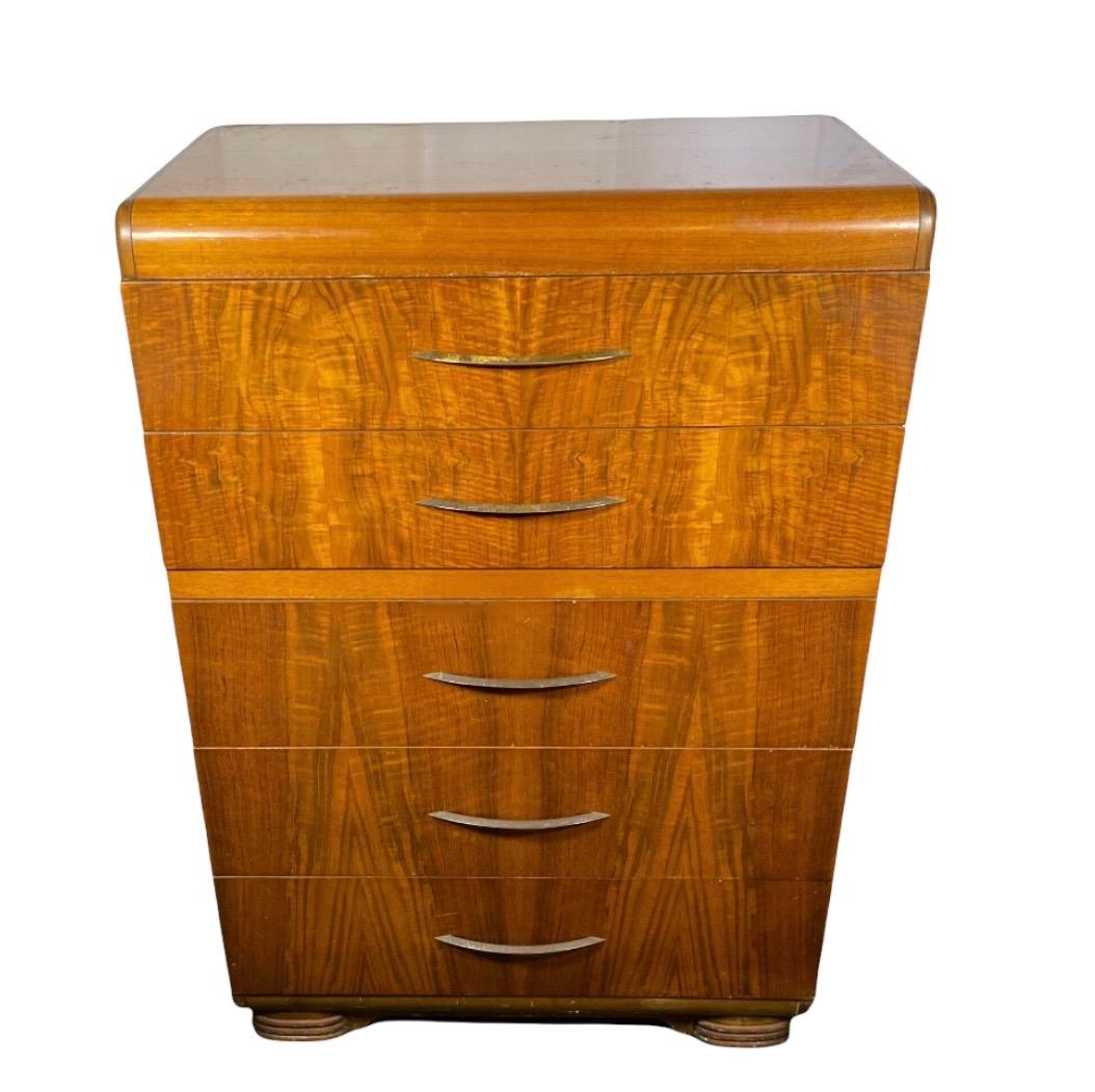 This Art Deco Highboy features smooth pulling dovetail joint drawers and is in great shape! 

Dimensions: 34W 19D 50H.