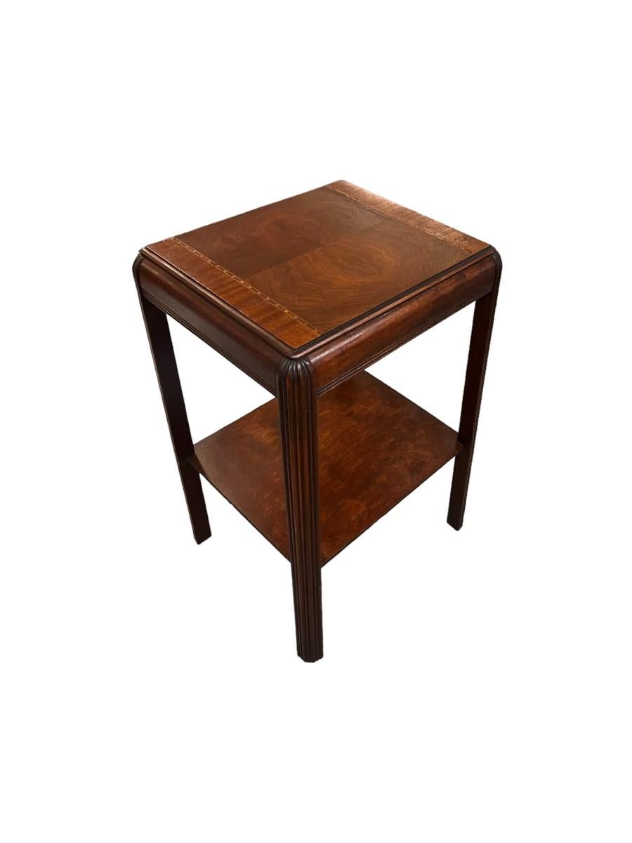   Vintage Art Deco Waterfall Mahogany End Table or Accent Table with low shelf for storage. The table top has book-matched Burl Accents and Wood Inlays. In great vintage condition.

Dimensions. 18W 16D 27.5H Overall
                      10H to 1st