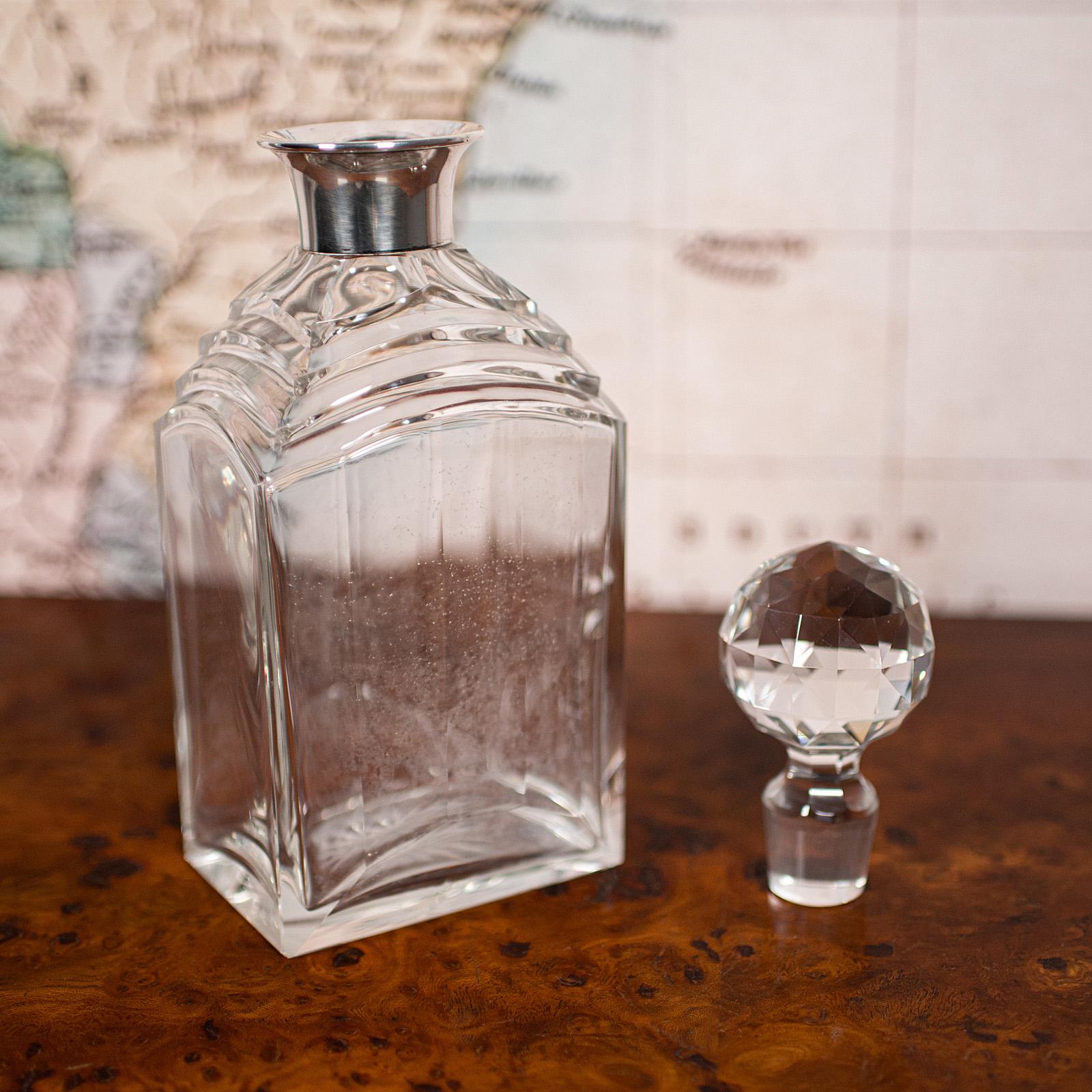 
This is a vintage Art Deco whiskey decanter. An English, glass and silver spirit vessel, hallmarked in Birmingham, circa 1930.

Appealing example from the Art Deco period
Displays a desirable aged patina throughout
Quality glass presents a bright