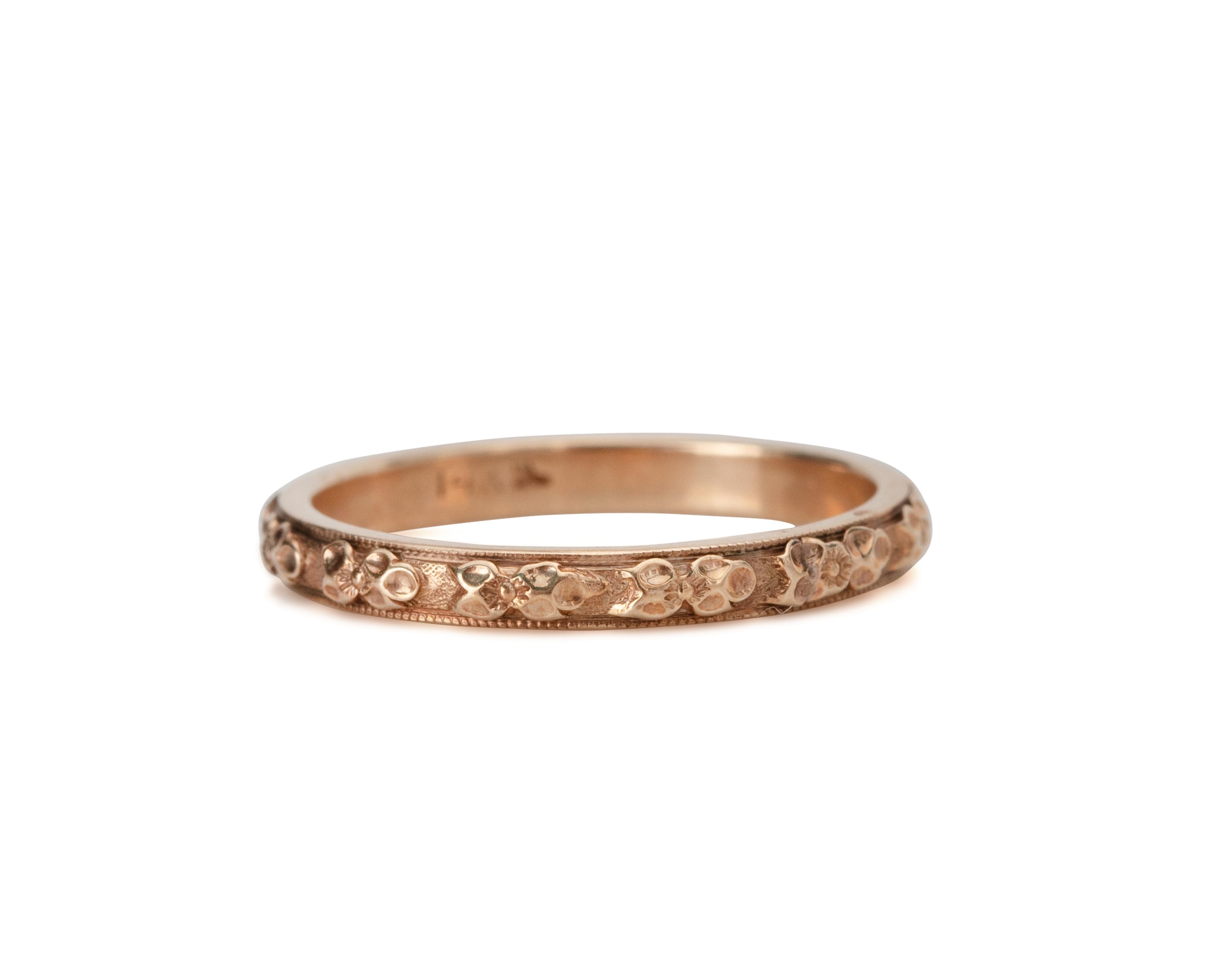 Description: 
This piece is a genuine 1920's yellow gold wedding band! This beautiful dainty band is an excellent example of the early 20th-century style! Likely from the 1920's this Art Deco beauty features a floral carved design all of the way