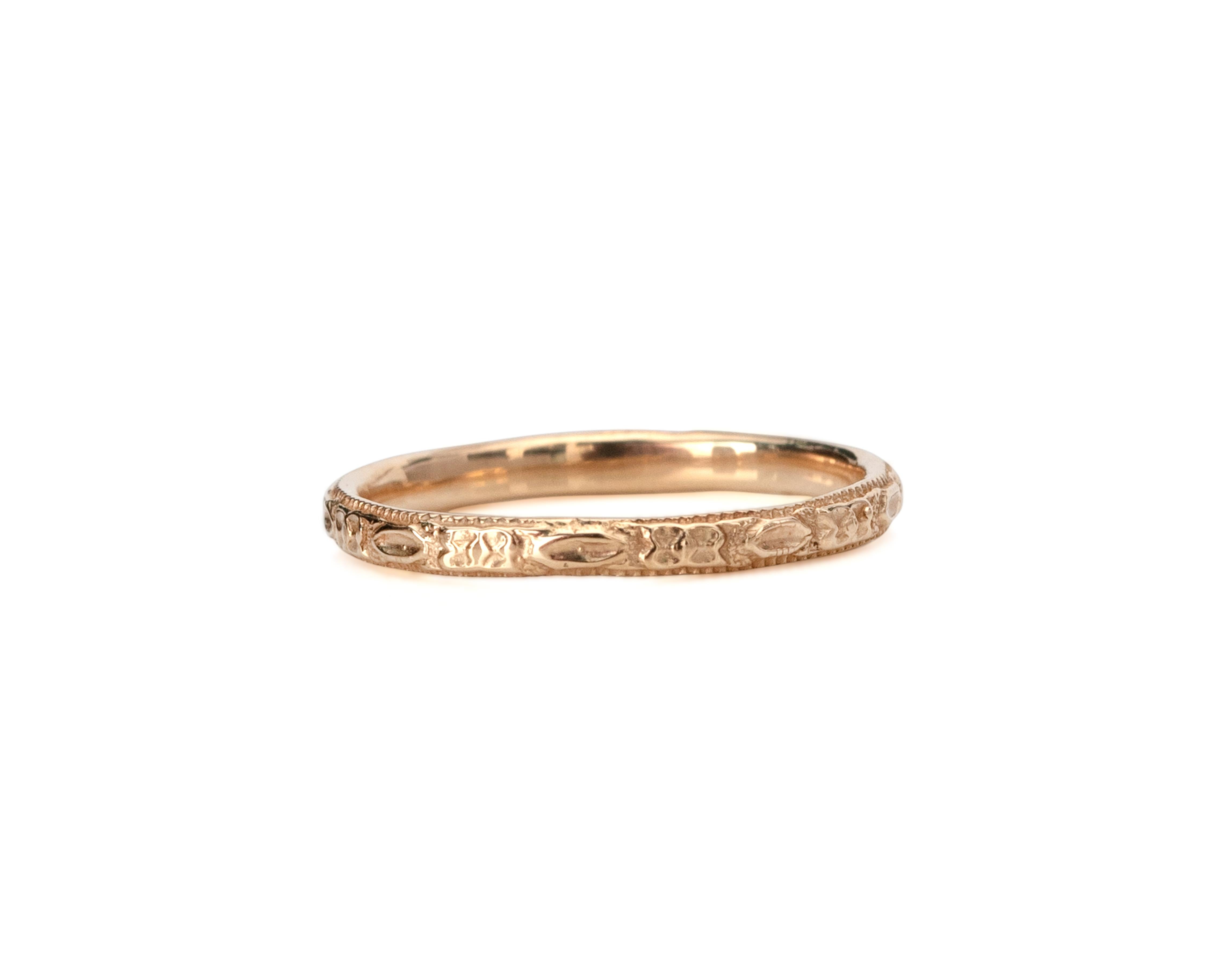 Description: 
This piece is a genuine 1930's yellow gold wedding band! This beautiful dainty band is an excellent example of the early 20th-century style! Likely from the 1930's this Art Deco beauty features a floral carved design all of the way
