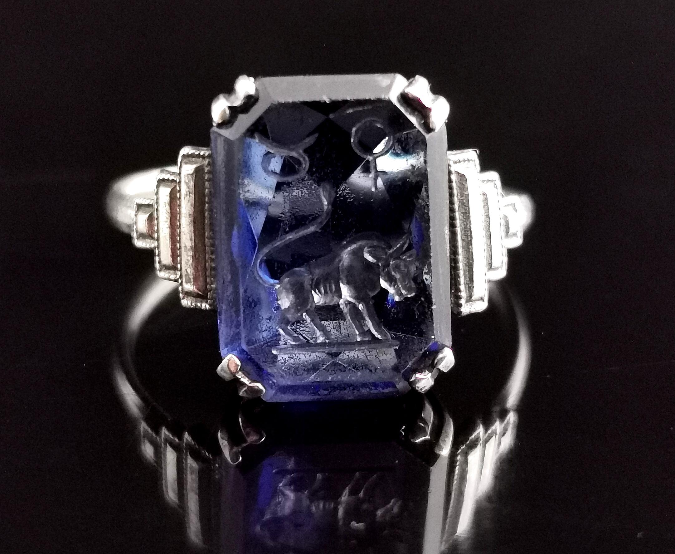 A handsome and unusual vintage, Art Deco era Zodiac intaglio ring.

Crafted in sterling silver it has attractive stepped shoulders and is claw set with a blue glass or paste intaglio.

The intaglio is carved with an image and symbols for Taurus