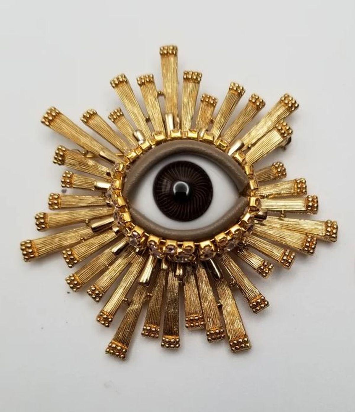 Simply Beautiful! Vintage Mid Century Modern Art Glass Evil Eye Golden Statement Brooch Pin. Centering an Art Glass Evil Eye. Surrounded by Striking Hand crafted Gold tone Decorative Rods mounting. Evil eye protection piece. More Beautiful in real