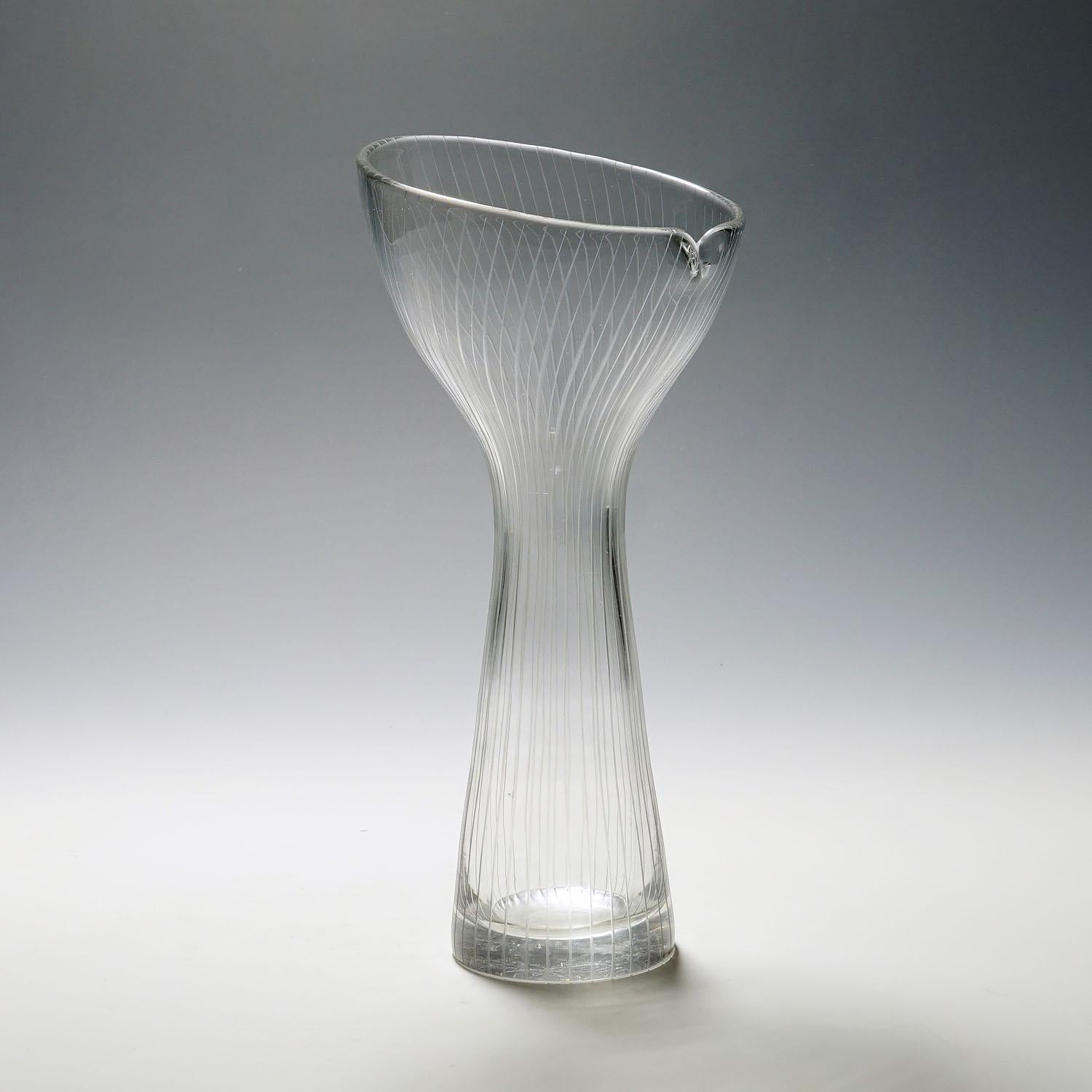 Vintage Art glass vase by Tapio Wirkkala for Iittala 1954

A large vintage art glass vase designed by Tapio Wirkkala for Iittala Glassworks in 1951, produced in 1954. Mold blown crystal clear glass with fine vertical line cuttings. Marked with