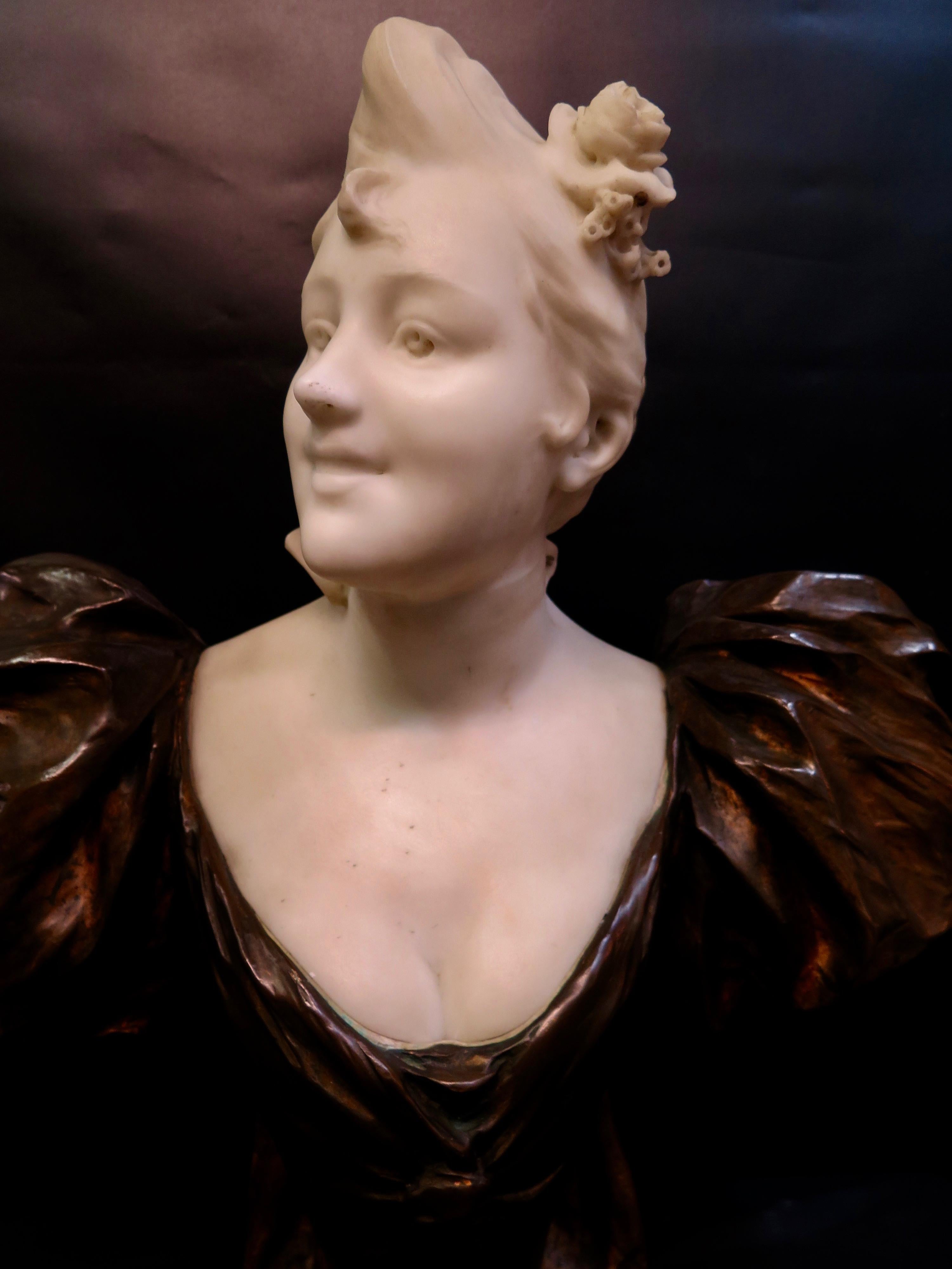 This vintage, circa 1895, Art Nouveau bronze & marble bust was designed & executed by Victor Leopold Bruyneel. This artist presents a wonderful interpretation of a French femme fatale. The richly patinated low cut dress with flaring sleeves