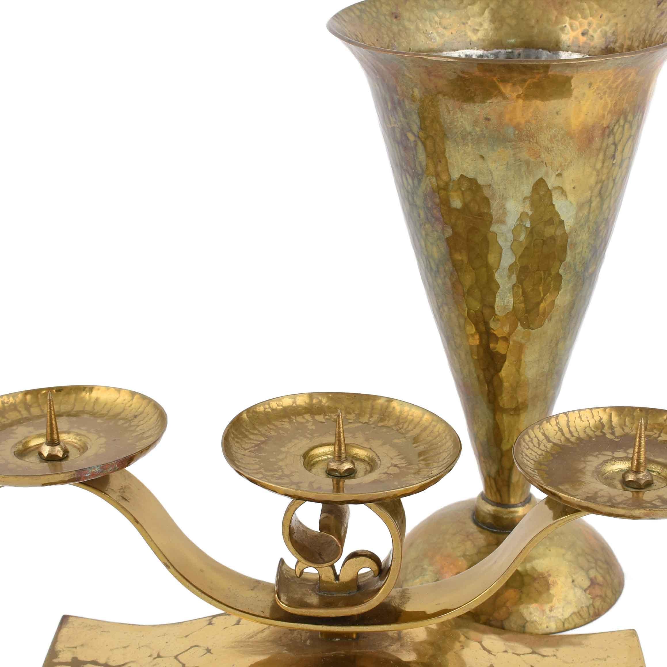 Art Deco Candle Holder and Vase is an original decorative pair of objects realized in the 1930s. 

Original brass. The couple includes: one brass vase (h. 20.5 cm) and one brass candle holder (h. 10 cm ca). 

Monogrammed on the base HO. 

Good