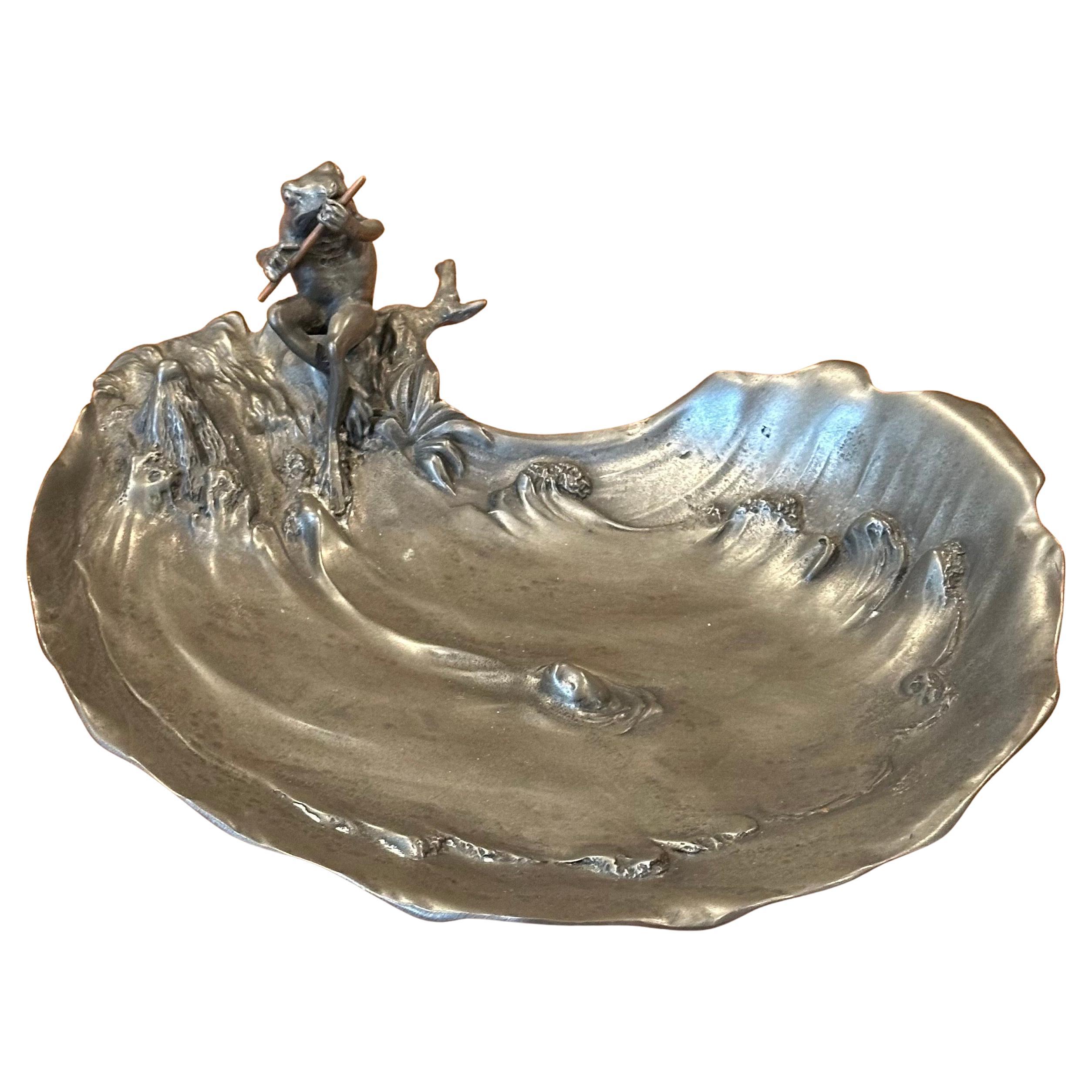 Vintage art nouveau pewter frog bowl / catch-all by Achille Gamba of Italy, circa 1920s.  This early 20th century pewter dish with frog sitting by the edge of a pond playing the flute, with wave, fish, branch foot, and vegetation details is signed