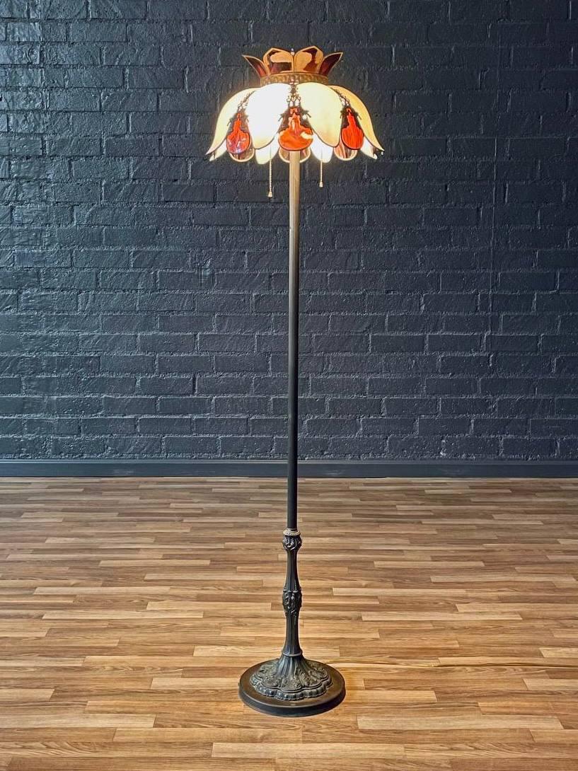 Condition: Original Vintage Condition 

Materials: Patinated Metal, Original Slag Glass Shade

This vintage Art Nouveau-style floor lamp from the 1960s captures the romantic spirit of early 20th-century design with its ornate patinated metal base