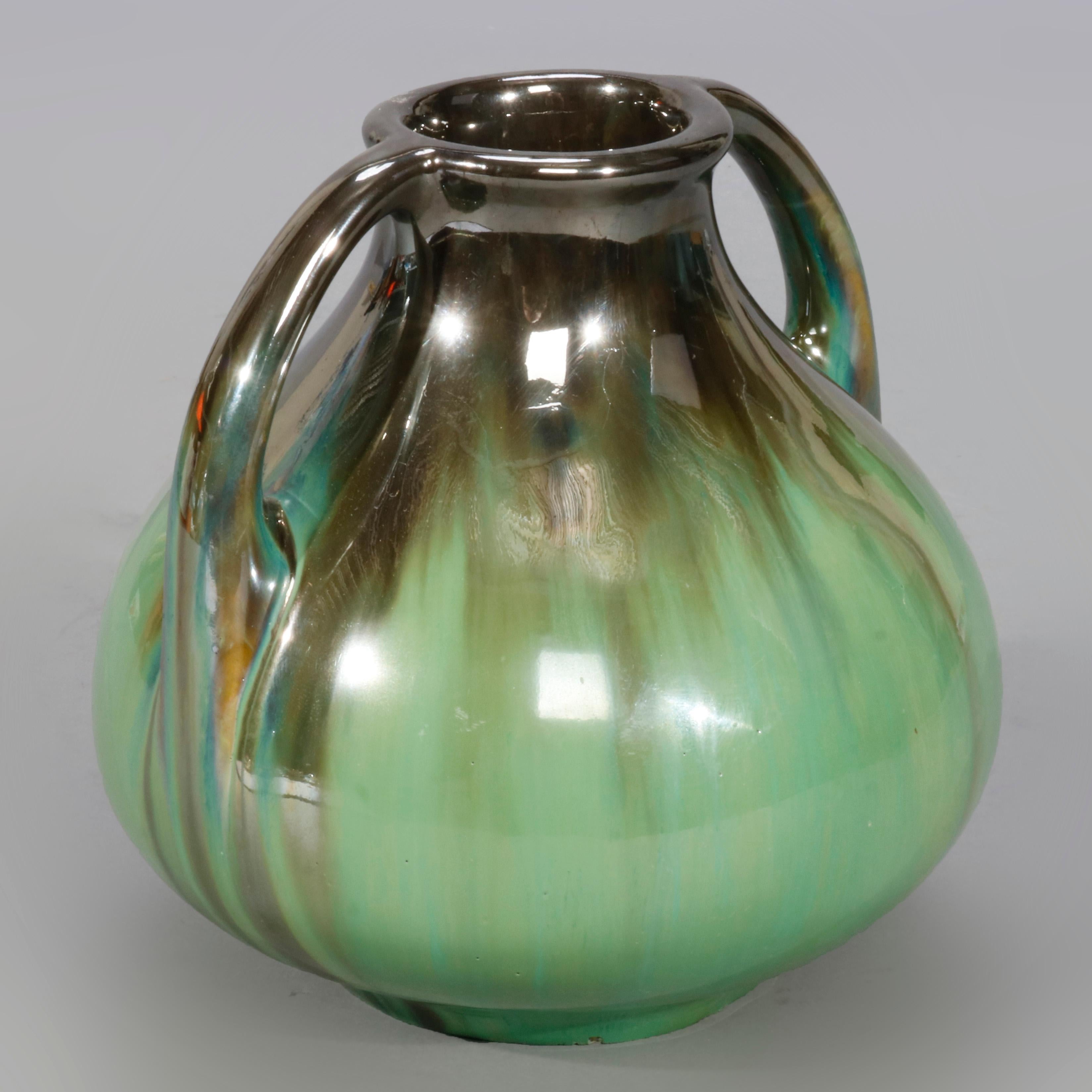 A vintage vase by Fulper offers gourd form with double handles and mirrored green drip glaze finish, marked n base as photographed, 20th century

Measures: 6