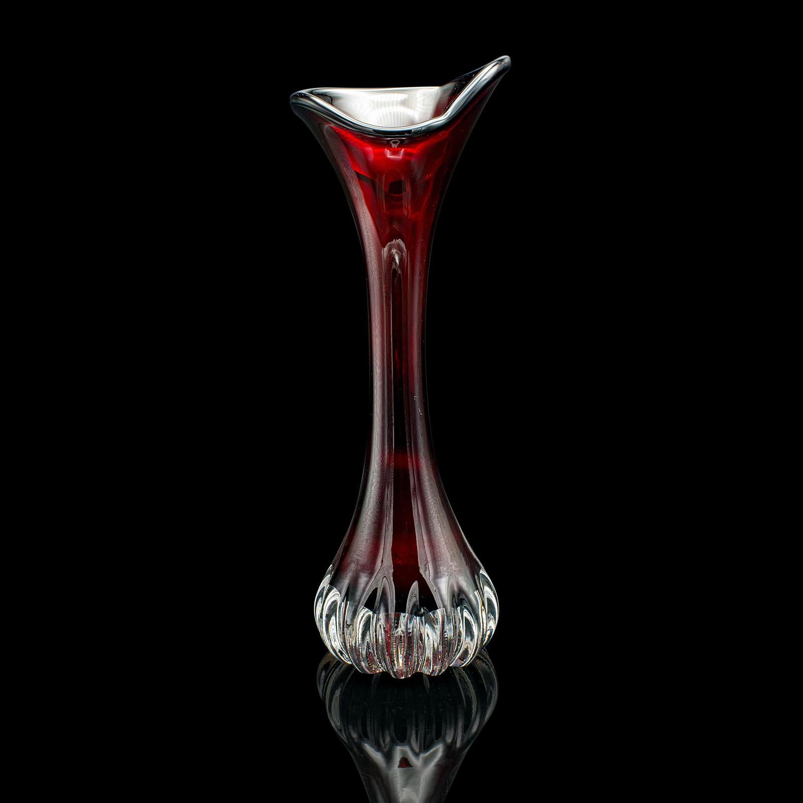 This is a vintage art vase. A Swedish, glass stem sleeve, dating to the mid 20th century, circa 1960.

Exceptional colour to this delightful Swedish art vase
Displays a desirable aged patina and in good order
Blown glass with a deep garnet red hue,