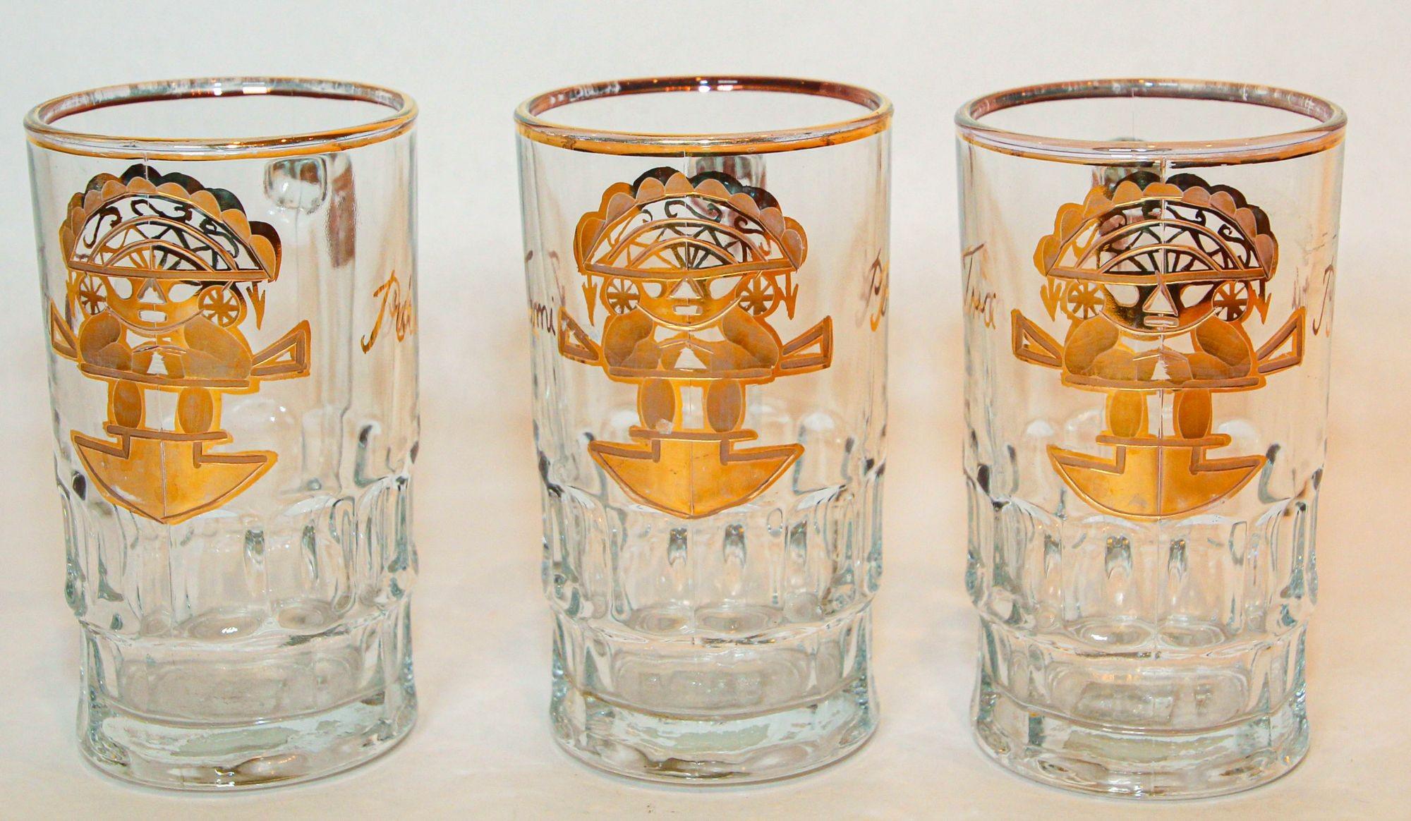 Vintage Artesania Tabuisa Tumi Peruvian God Gold Glass Mugs Set of 3.
Set up the Tiki Bar and serve your favorite drink or beer, featuring an Aztec Tumi God.
The graphic is so striking and very modernist.
There are Inca God figure design in front of