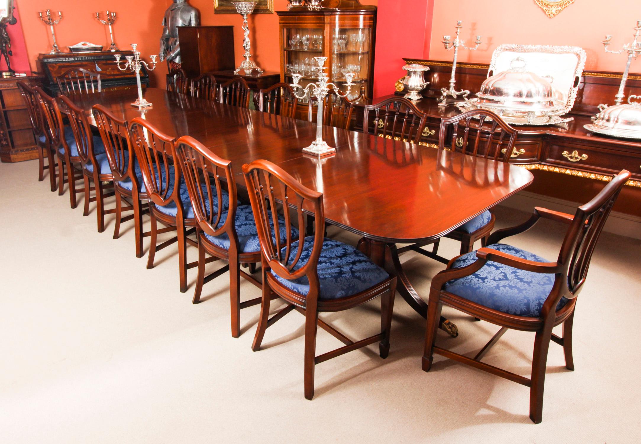 This is a superb dining set comprising a large Vintage handmade dining table in elegant George III style, by the master cabinetmakers Arthur Brett & Son, Norwich, Mid 20th C in date, and the matching set of sixteen dining chairs.
The triple pedestal