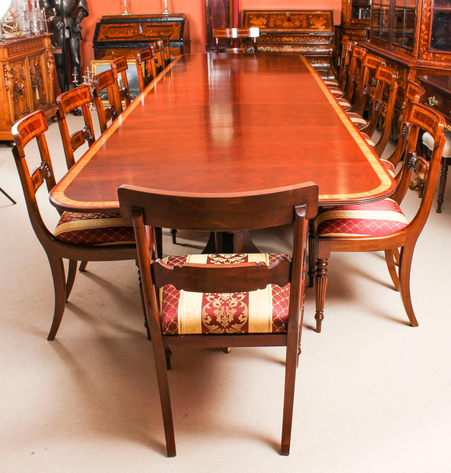 This is a superb dining set comprising a large vintage handmade dining table in elegant Regency style, by the master cabinetmakers Arthur Brett, mid-20th century in date, and a matching bespoke set of fourteen dining chairs.
The table, dating from